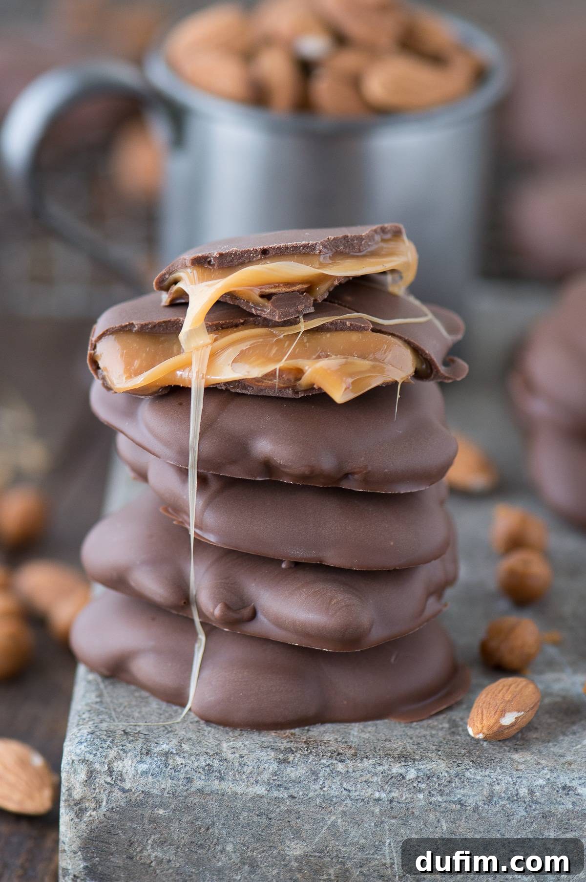 Williams Sonoma's Iconic Sticky Paws, Perfected at Home 9 A stack of Sticky Paws (chocolate caramel nut cluster) with visible gooey caramel between layers, highlighting their irresistible texture.