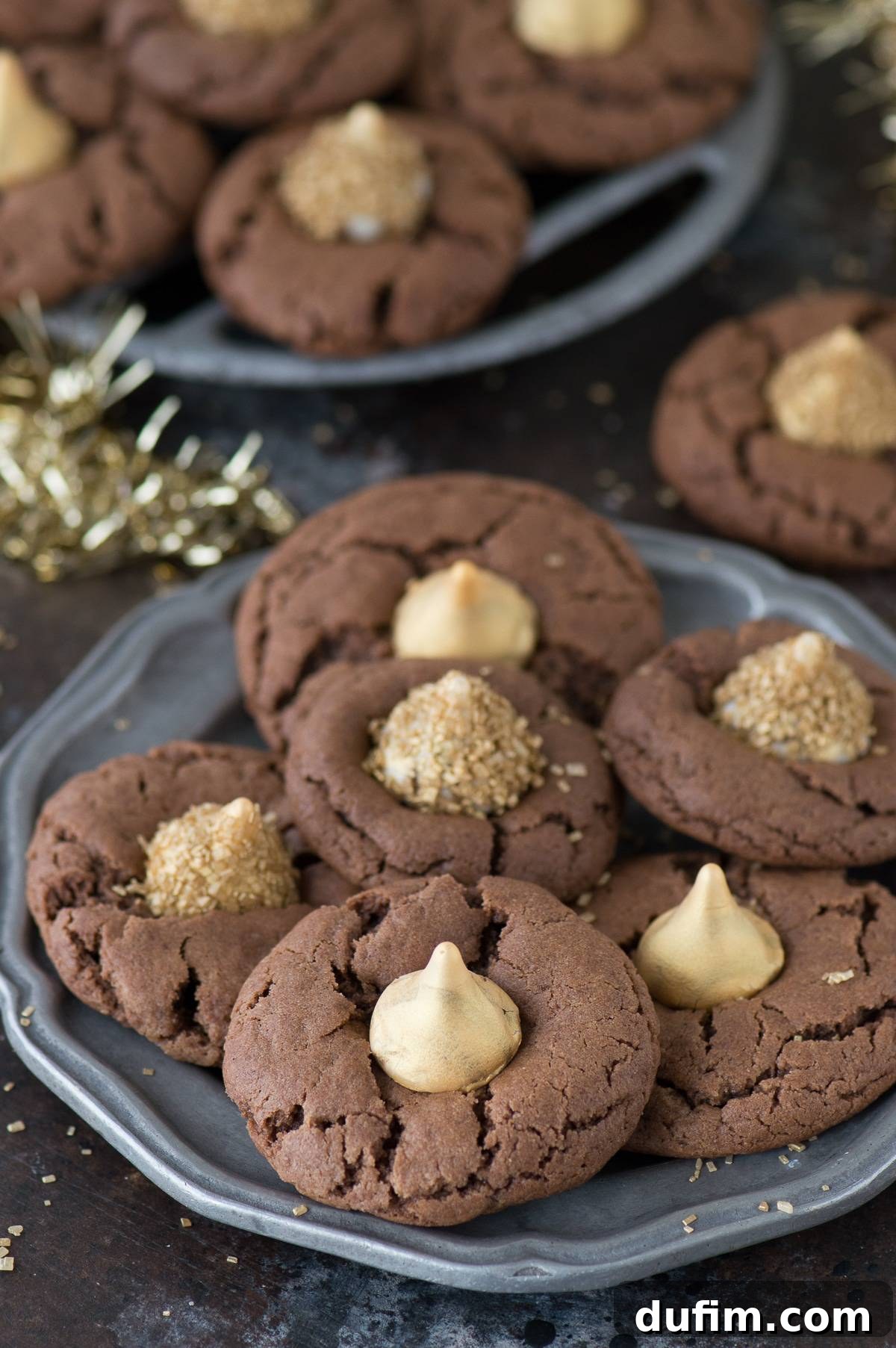 A festive plate of Midnight Kiss Cookies, garnished with gold Hershey's Kisses and holiday decor, perfect for New Year's Eve celebrations.