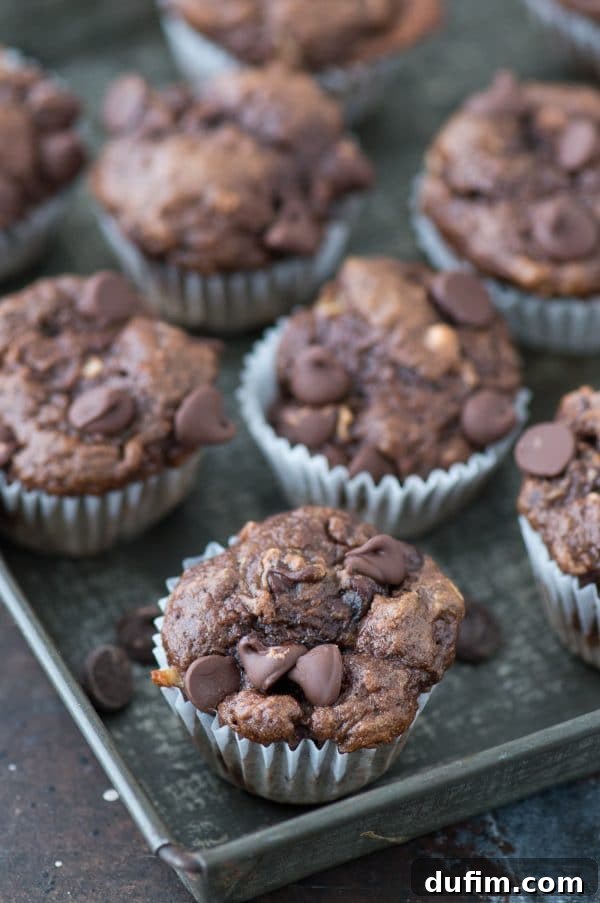 Guilt-Free Mini Chocolate Treats 6 A selection of healthier chocolate mini muffins arranged artfully on a cooling rack, freshly baked.