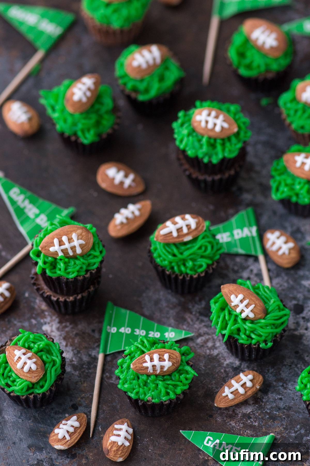 Touchdown Treats Reese Peanut Butter Cups 4 Several Reese's Peanut Butter Cups unwrapped and ready for topping with green frosting and almond footballs.