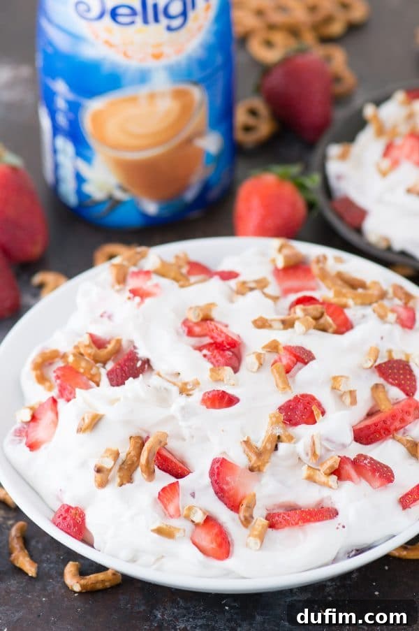 Five delicious, perfectly ripe strawberries are arranged artfully against a dark, rustic background, emphasizing freshness.