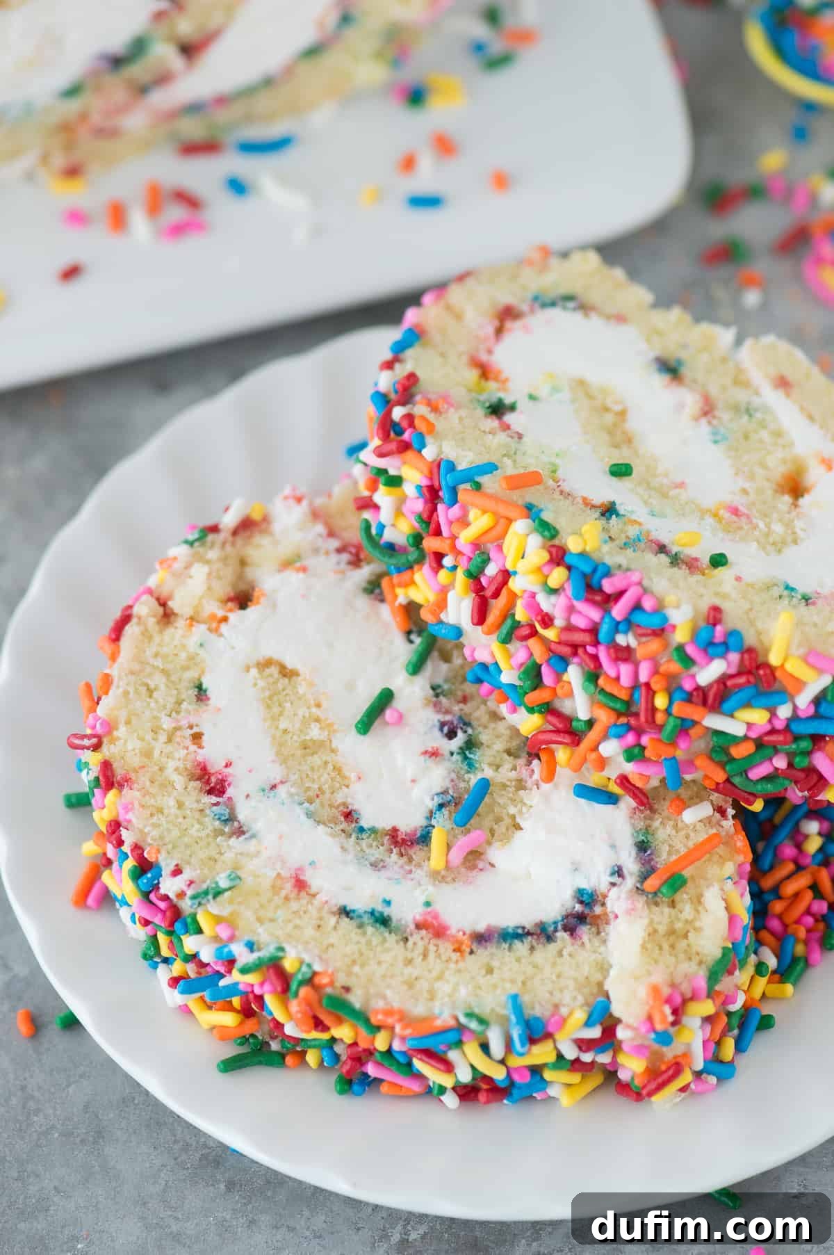 Colorful Confetti Cake Roll 4 A baked vanilla cake sheet on parchment paper, perfectly golden and ready to be rolled for a Funfetti Cake Roll.