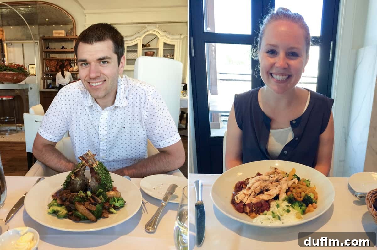 A couple dressed up, smiling and enjoying a fancy dinner date at a well-lit restaurant