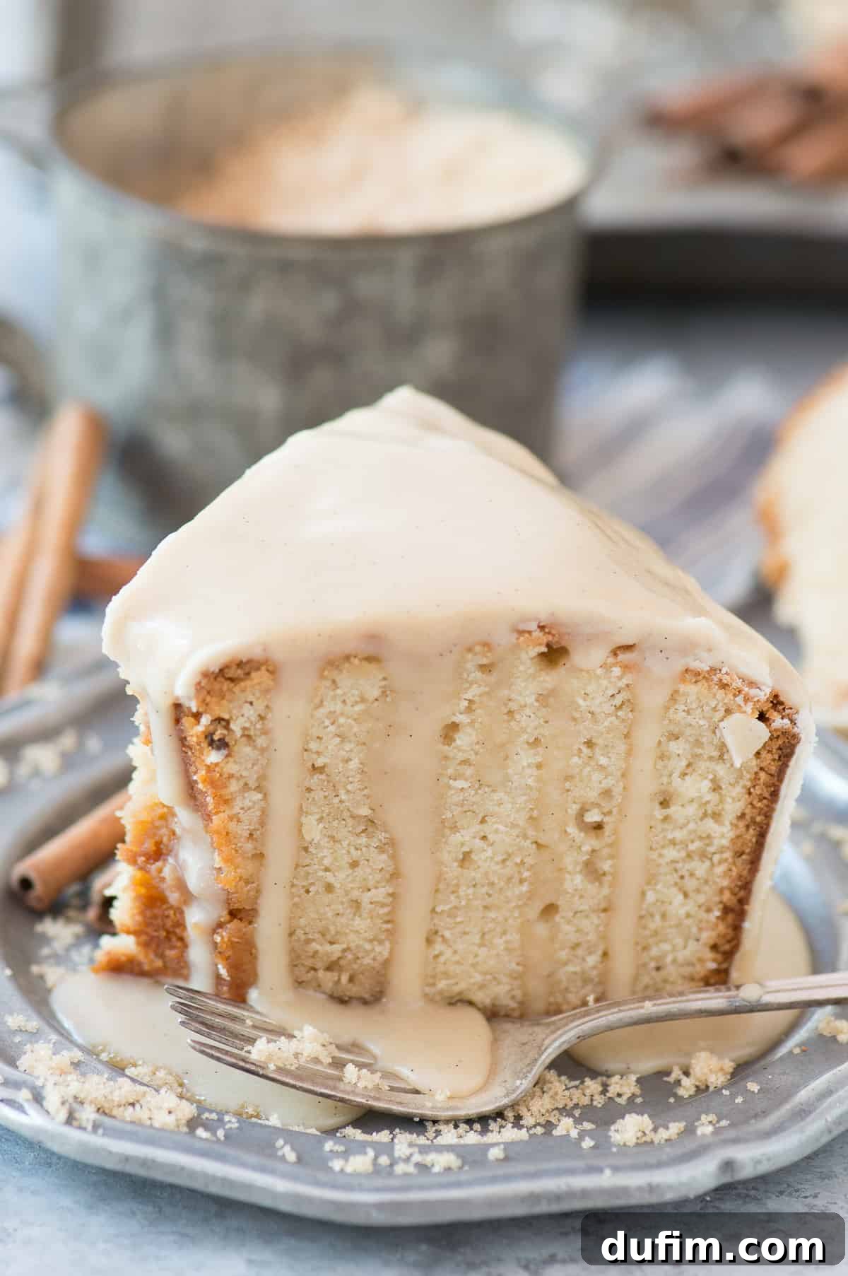 A beautiful, golden-brown brown sugar pound cake, freshly baked and topped with a luscious glaze, invitingly placed on a serving platter. This image highlights the cake's appealing texture and the sweet, glistening finish of its glaze, promising a comforting and delicious dessert experience for any family or social gathering.
