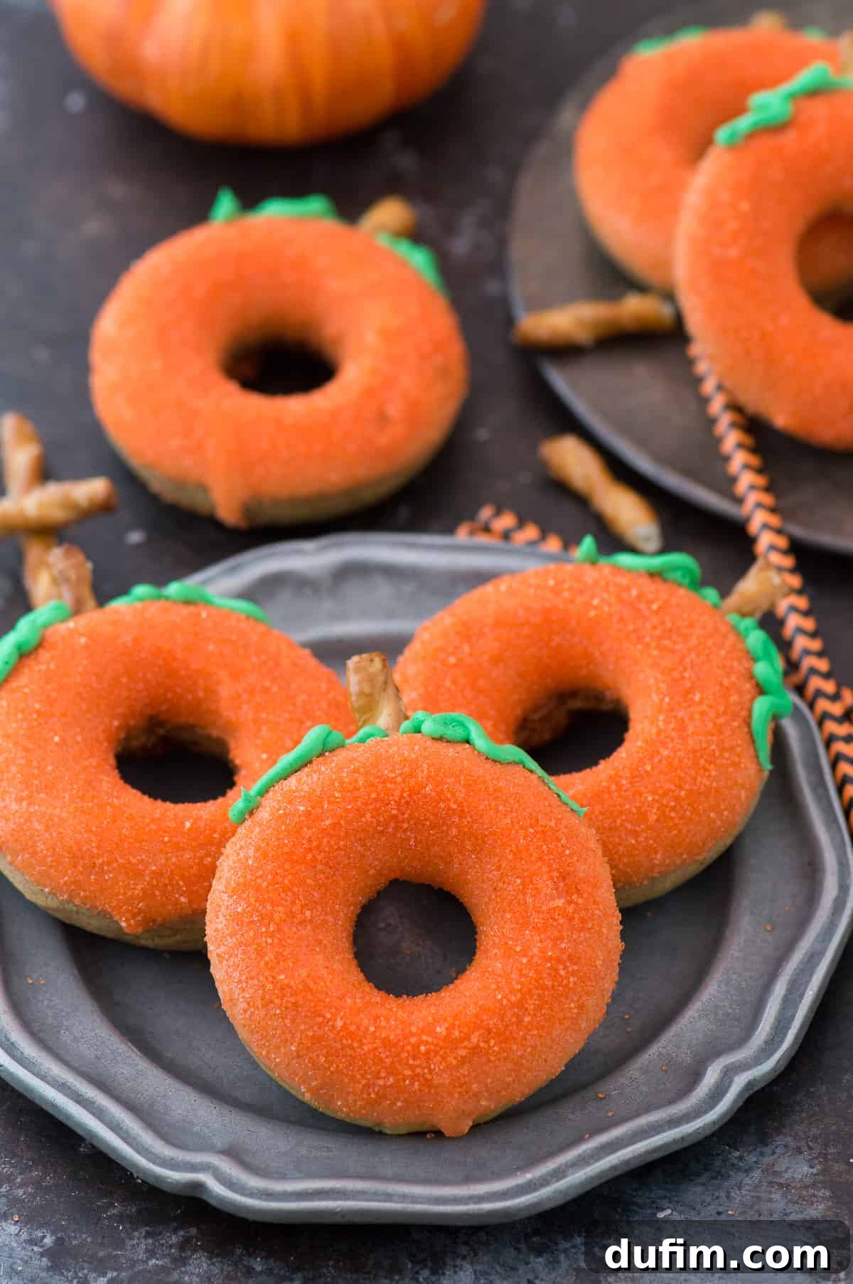 Golden Pumpkin Puffs 4 A tray of freshly baked, undecorated pumpkin donuts, golden brown and ready for glazing and decoration.