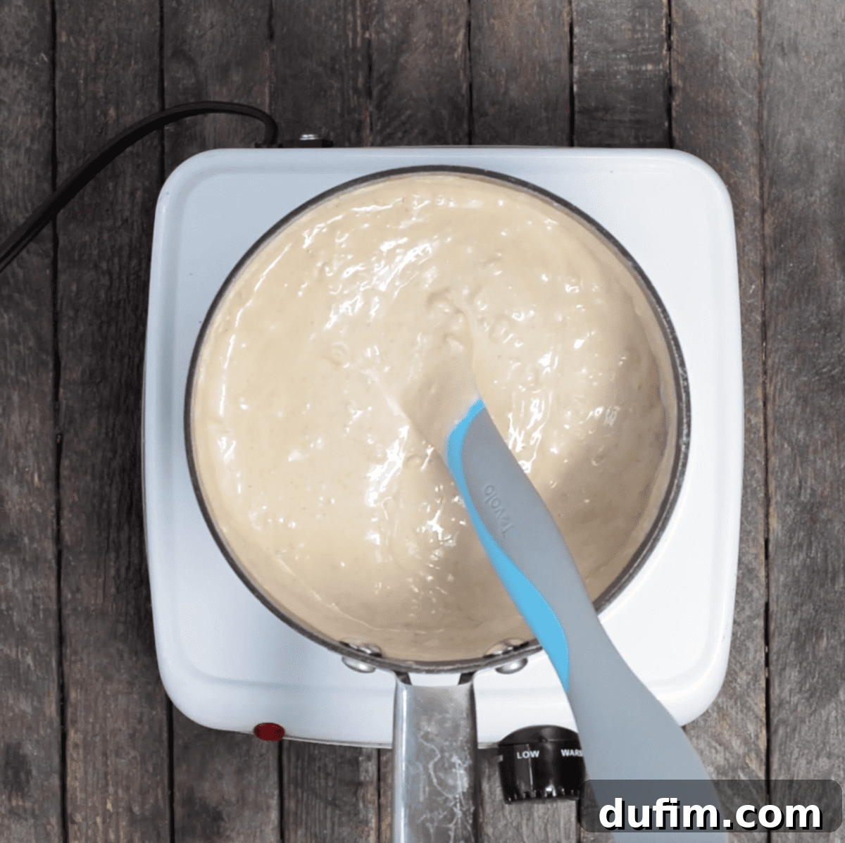 Close-up of the smooth, melted mixture of almond bark and peanut butter after stirring.