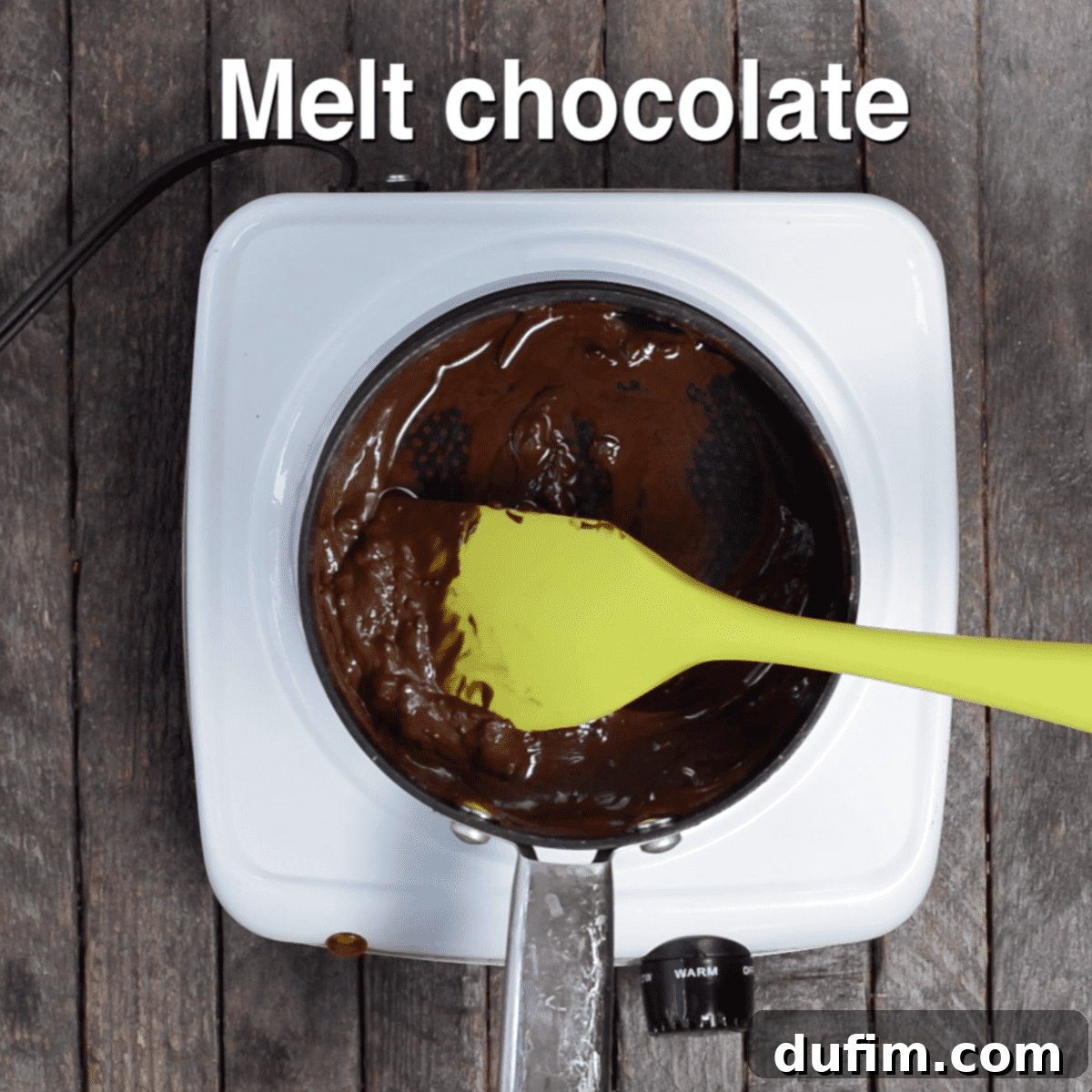 Semi-sweet chocolate chips and oil melting in a small pot on the stove, beginning to form a smooth mixture.