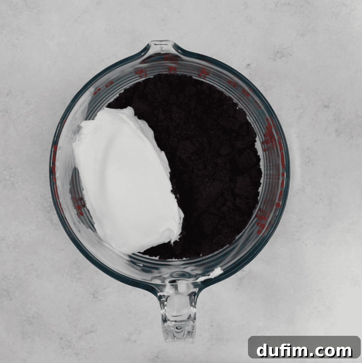 Decadent Turtle Oreo Truffles 5 Oreo crumbs and cream cheese in a glass bowl, ready to be mixed