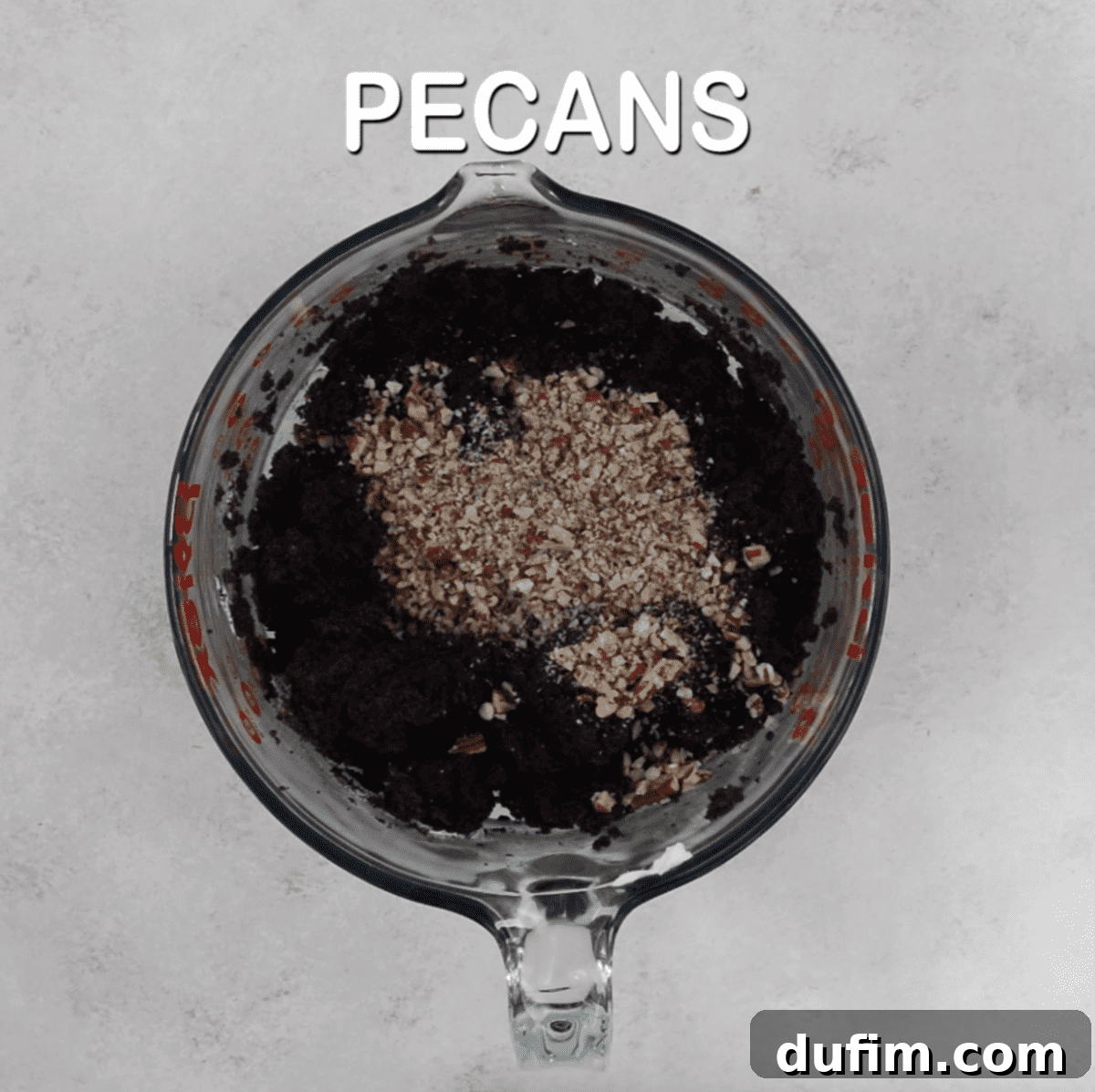 Decadent Turtle Oreo Truffles 7 Oreo ball mixture with chopped pecans in a glass bowl