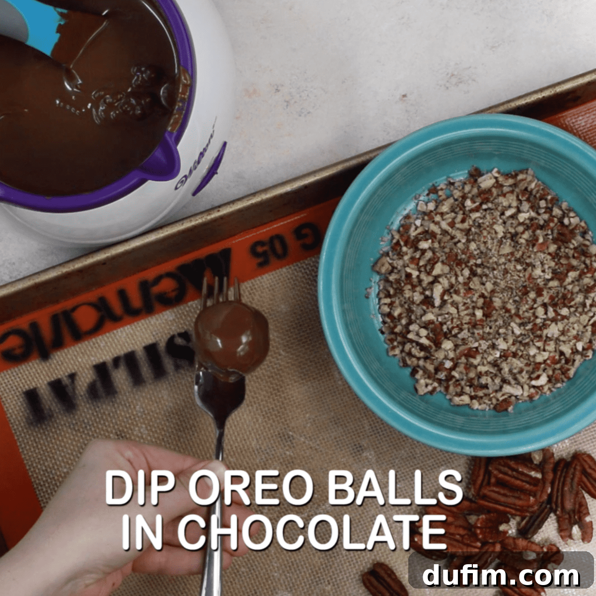 Decadent Turtle Oreo Truffles 10 Dipping an Oreo ball into melted chocolate using a fork