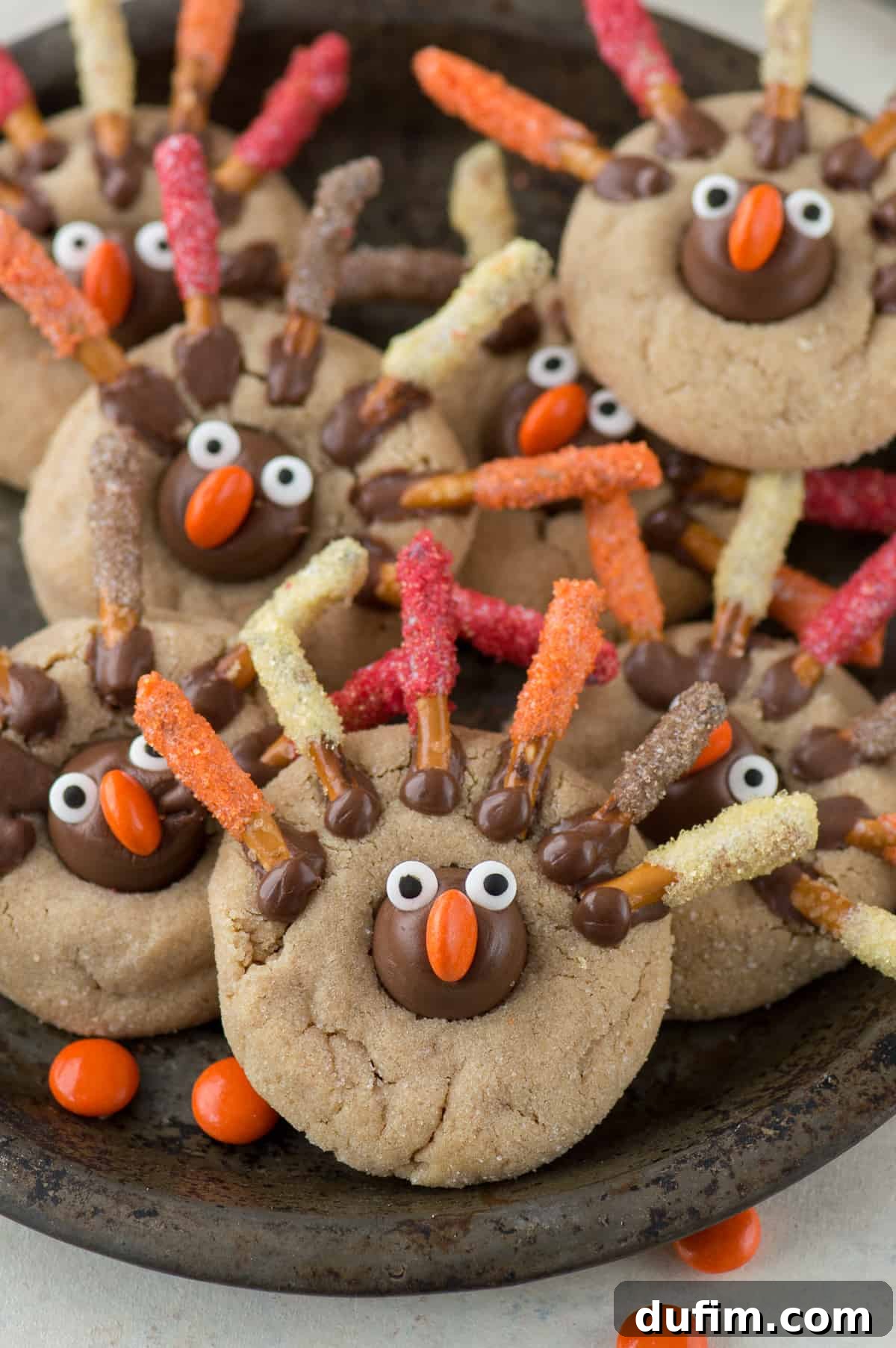 Turkish Bloom Cookies 4 Close-up of Thanksgiving turkey blossom cookies on a cooling rack, showcasing colorful pretzel feathers.