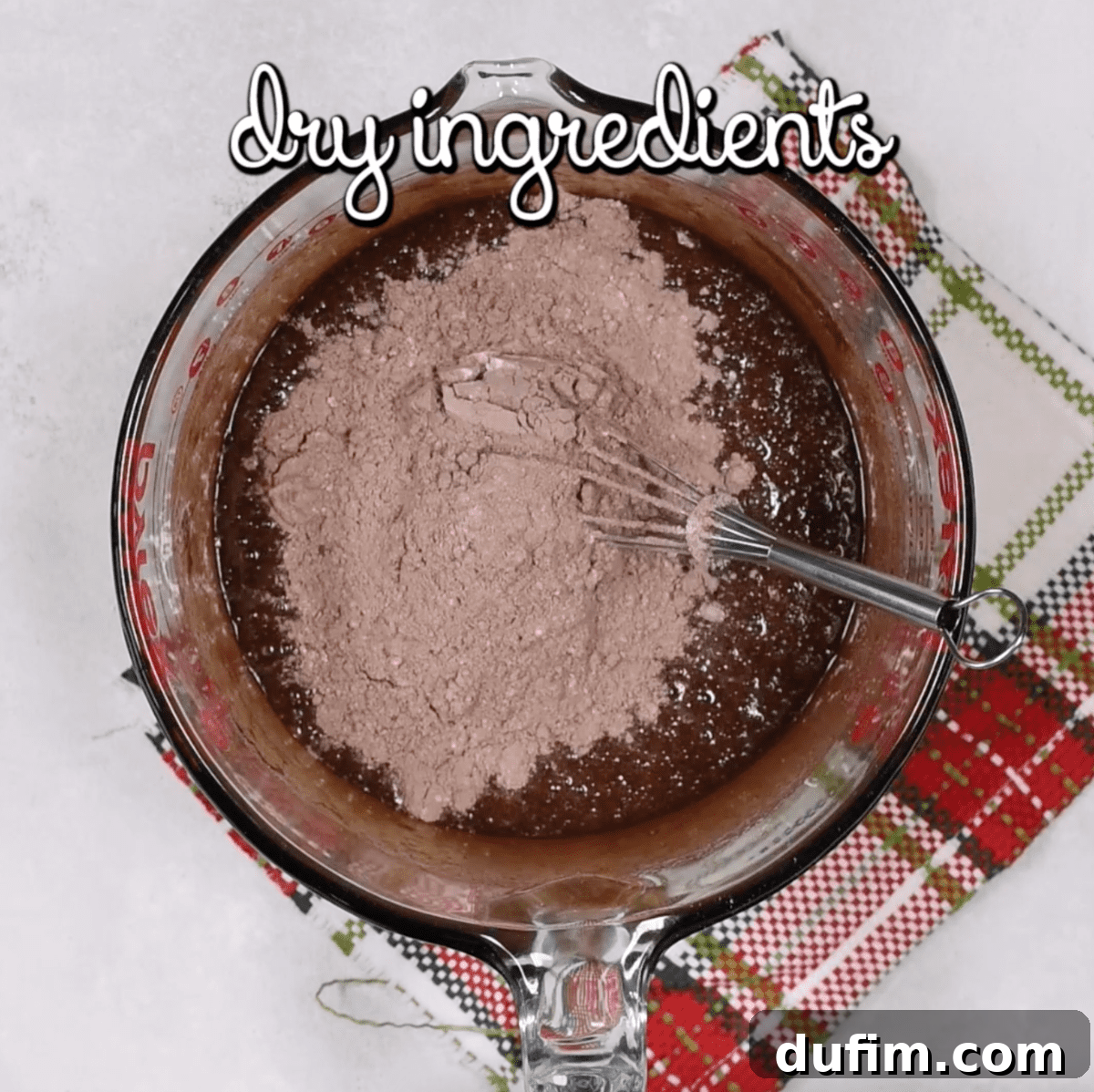 Fudgy Crinkle Delights 6 Dry flour mixture being gradually added to the rich chocolate cookie dough, ready for mixing until just combined.
