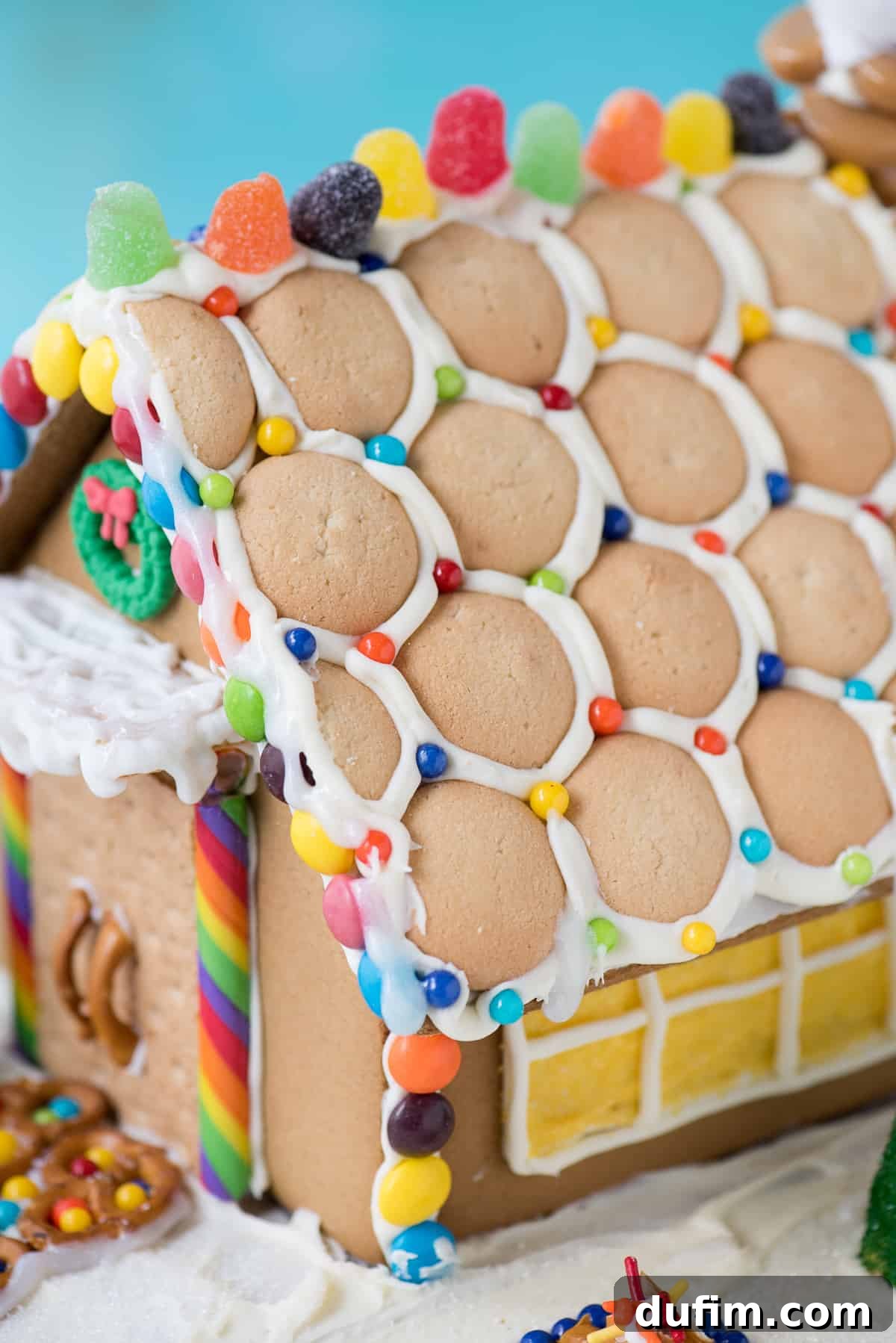 An overhead view capturing the intricate details of gingerbread house decorating with various candies and icing.