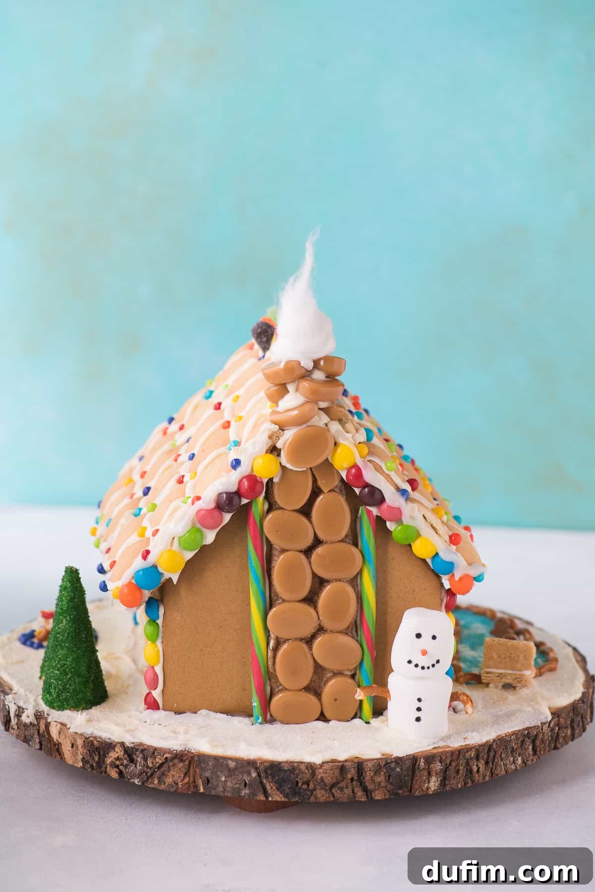 A completed gingerbread house, showcasing all the festive decorations and an inviting winter scene.