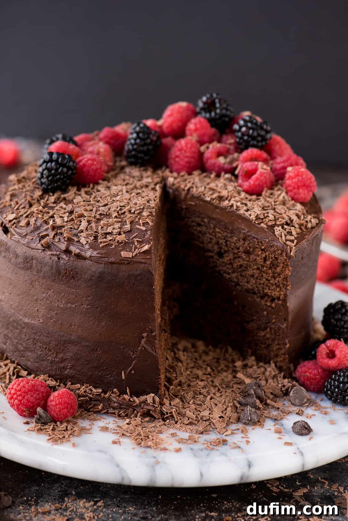 A two-layer chocolate velvet cake on a cooling rack, freshly baked and ready for frosting. The cake layers are perfectly even, suggesting the use of bake-even strips.