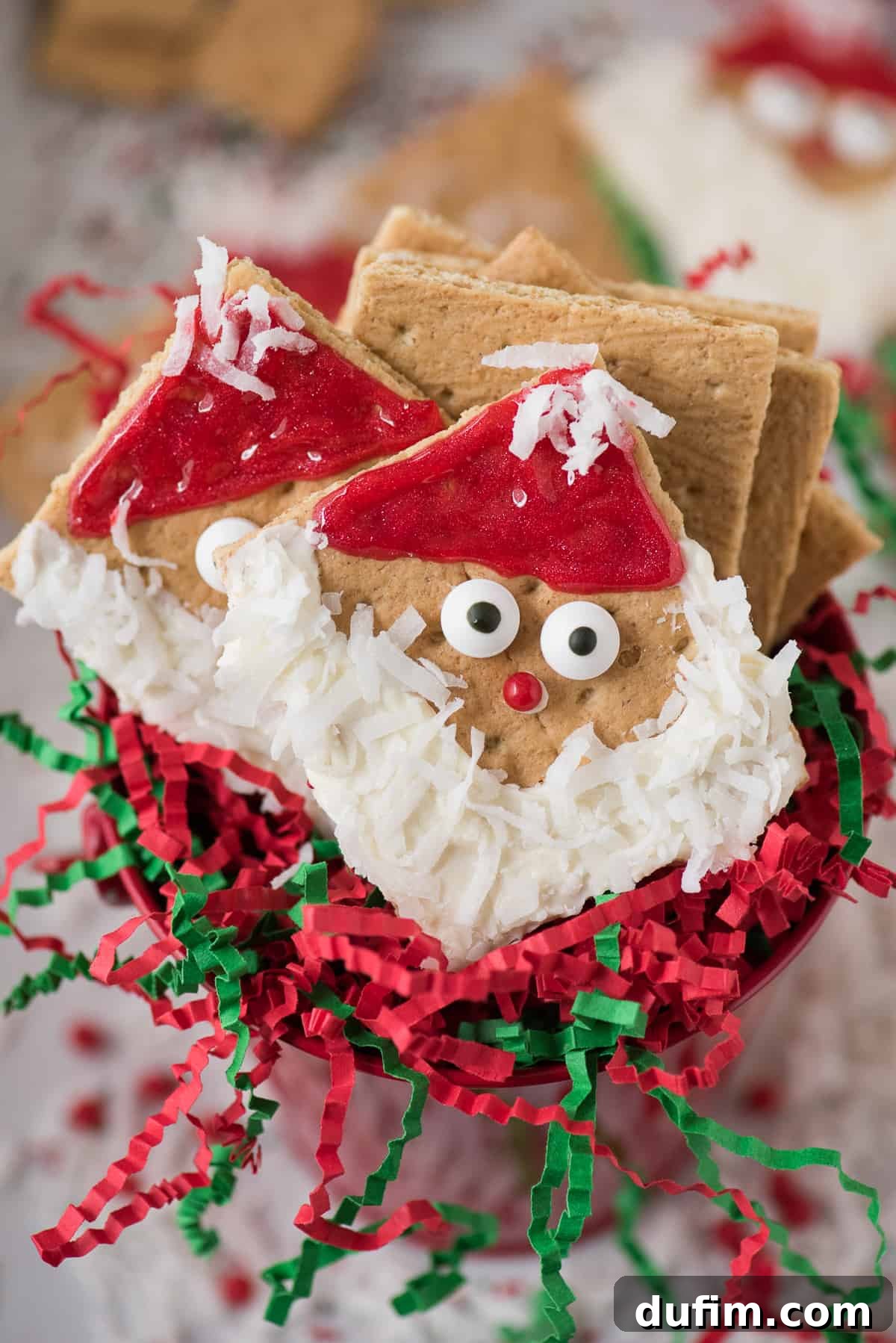 Another perspective of decorated Santa Graham Crackers, showing variations in expressions and hat designs.