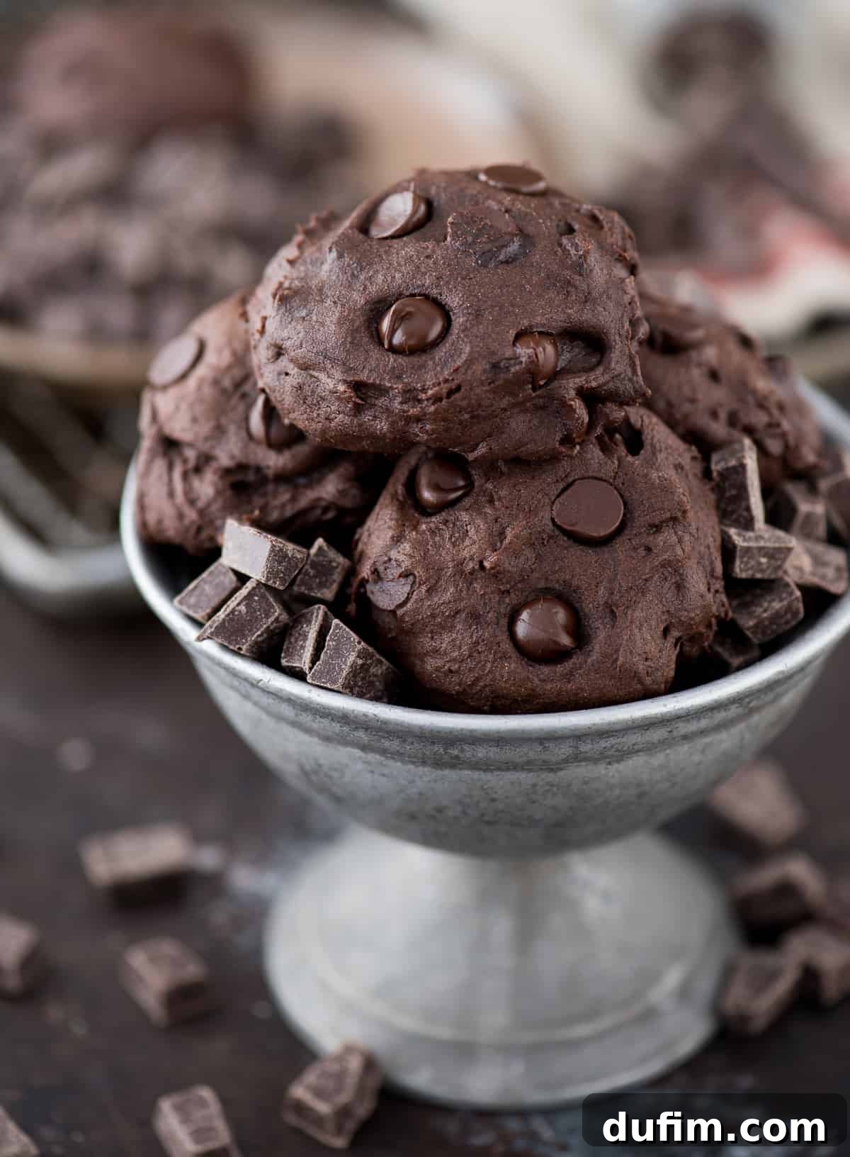 Prepping Your Healthier Dark Chocolate Cookie Dough Healthy dark chocolate coconut oil cookie dough in a bowl, speckled with small pieces of dark chocolate chips, ready for baking.