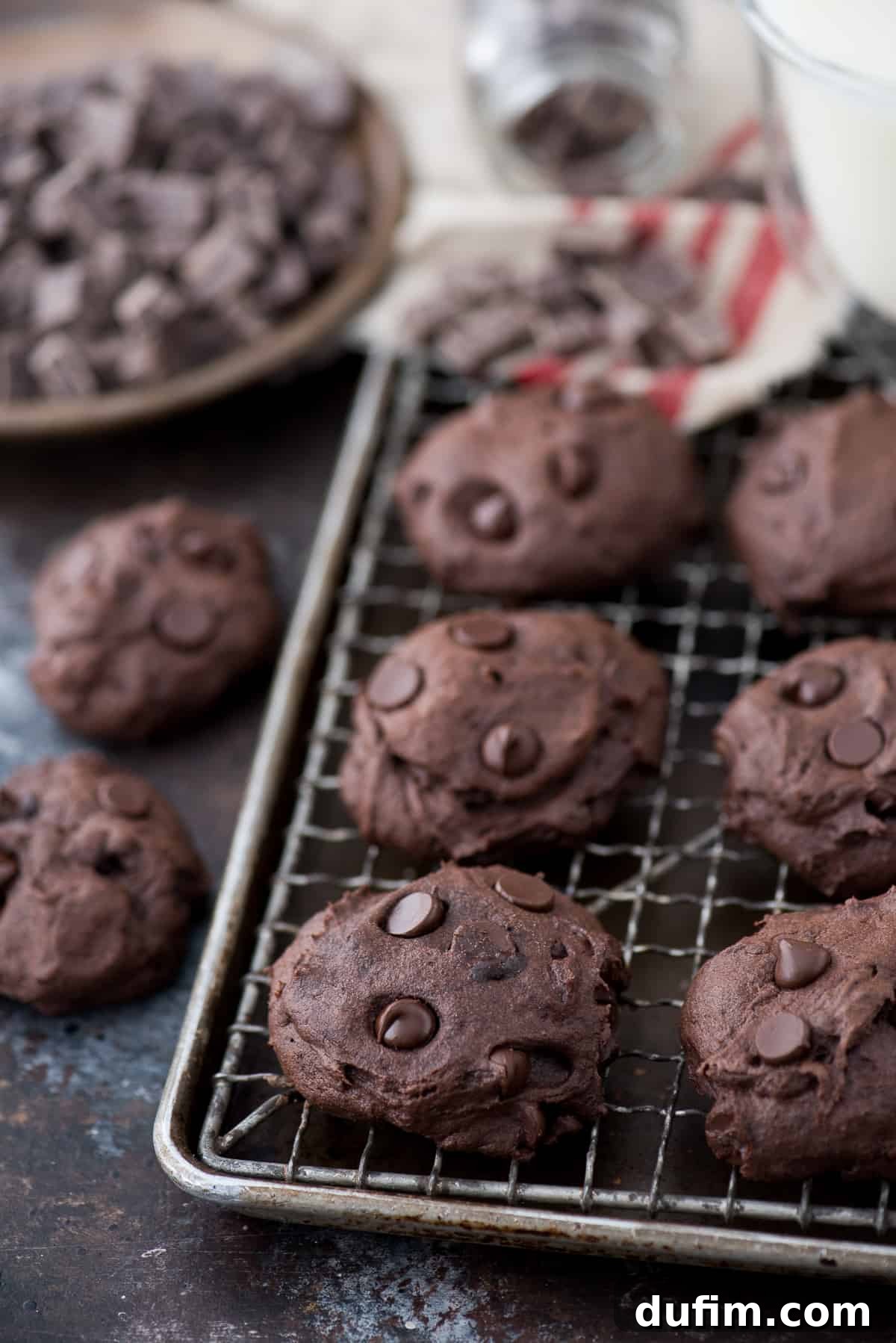 Wholesome Dark Chocolate Coconut Delights 2 Freshly baked healthier dark chocolate coconut oil cookies on a baking sheet, showcasing their rich color and melted chocolate chips.