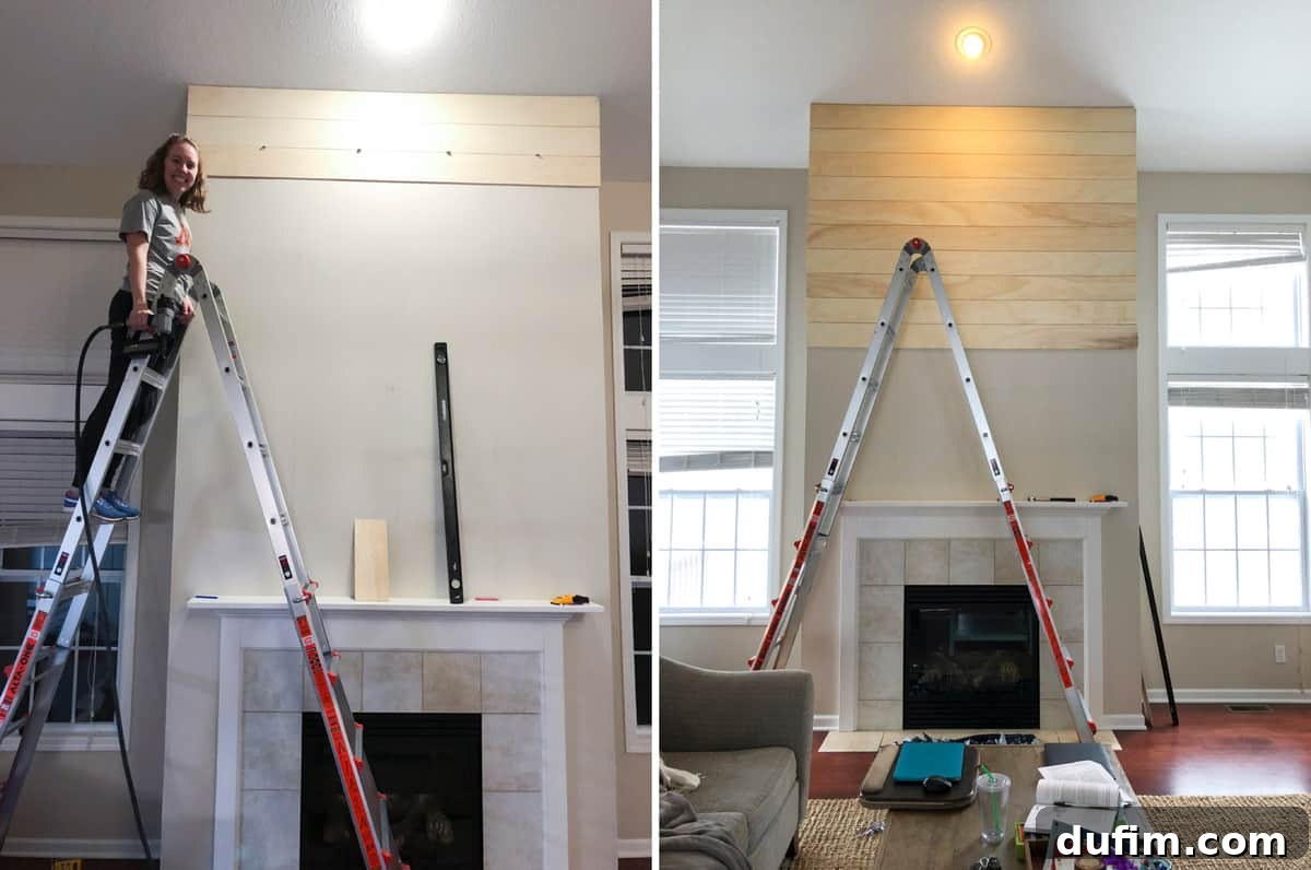 Close-up of shiplap boards being installed on a fireplace wall, showing progress of the DIY project with some boards already attached.