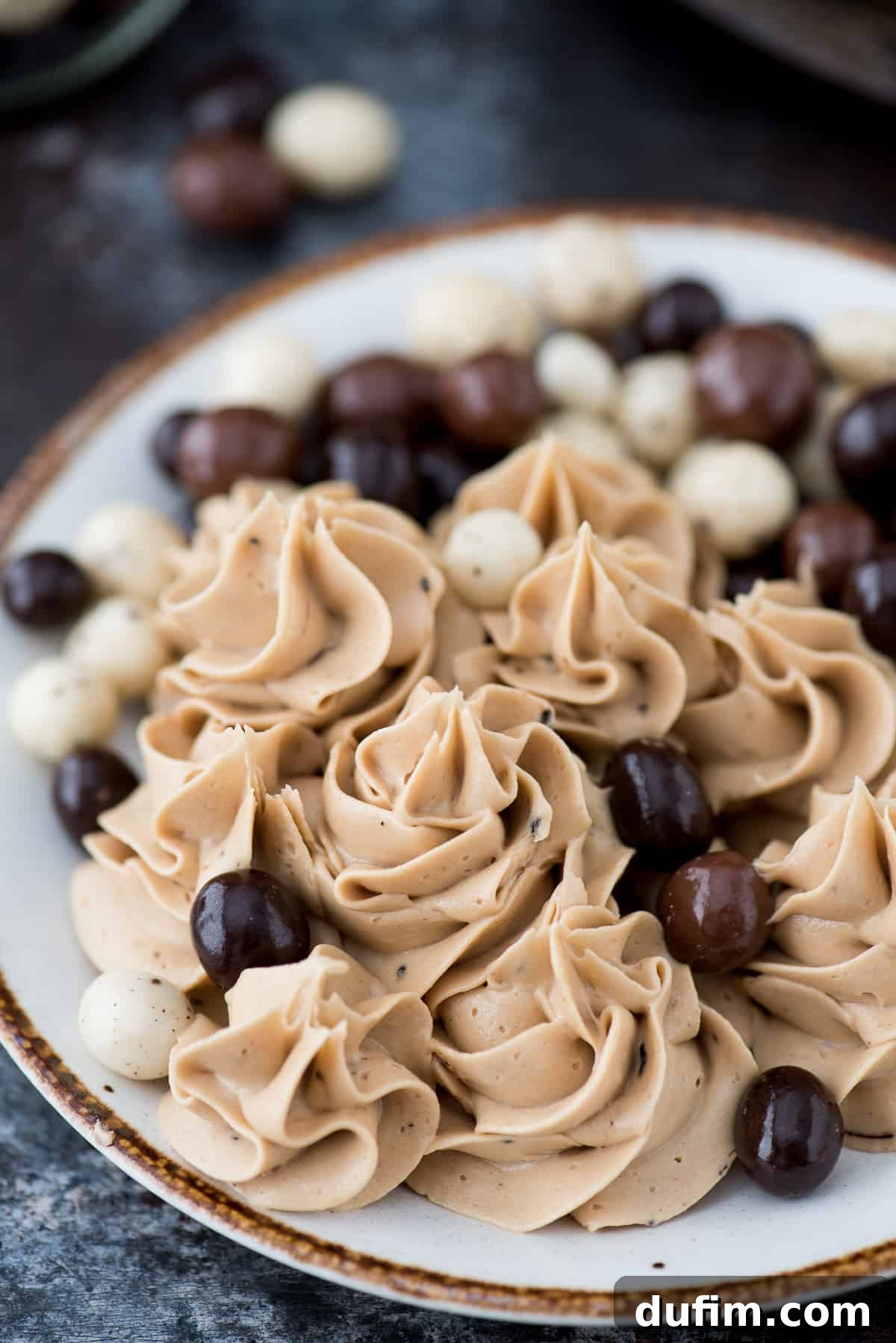 Decadent Coffee Frosting 2 A beautifully piped swirl of light brown coffee frosting, showcasing its smooth and airy texture. Perfect for topping cakes and cupcakes.