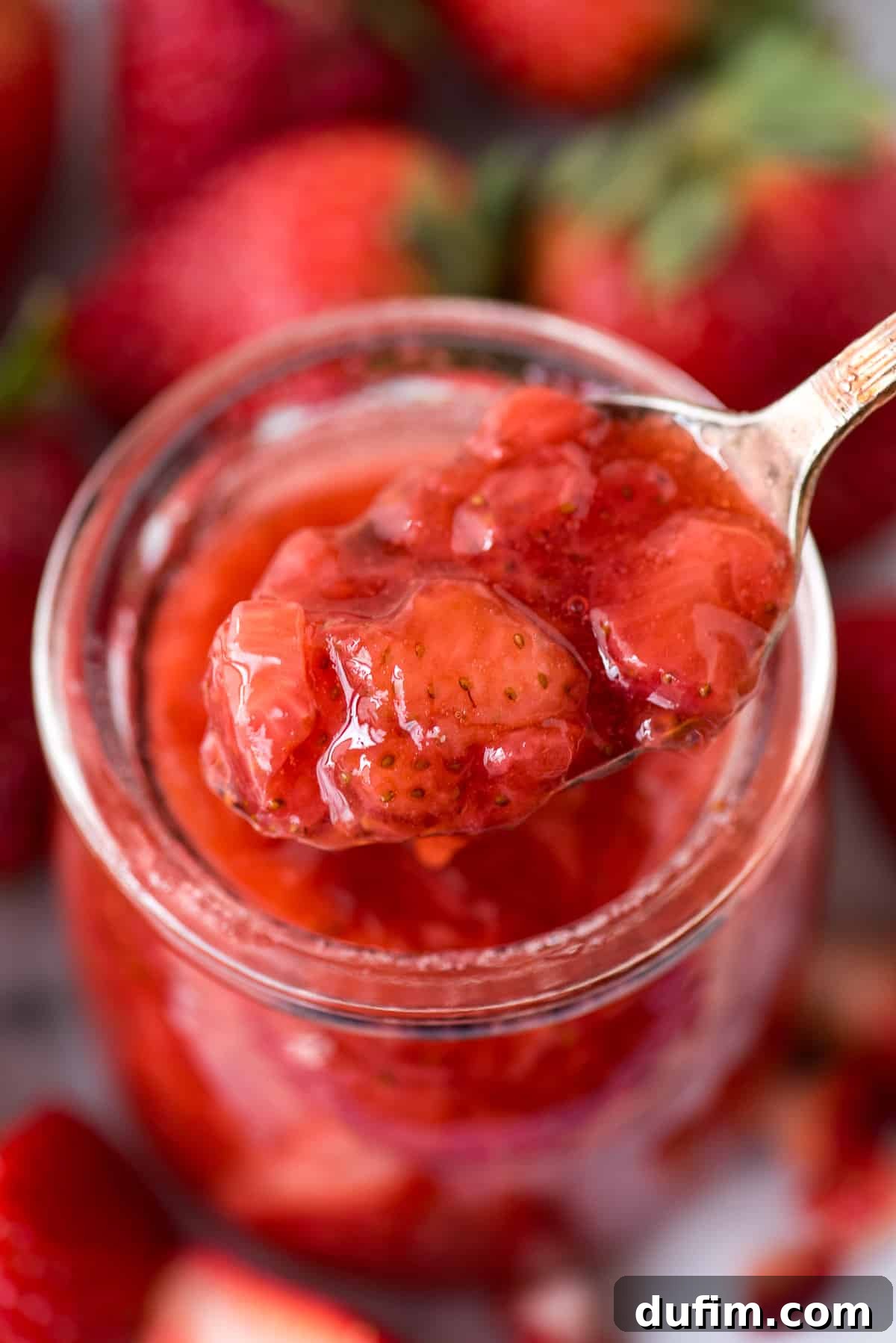 Luscious Strawberry Reduction 3 Close-up of a pot filled with bubbling strawberry sauce, showcasing the rich color and texture as it simmers.