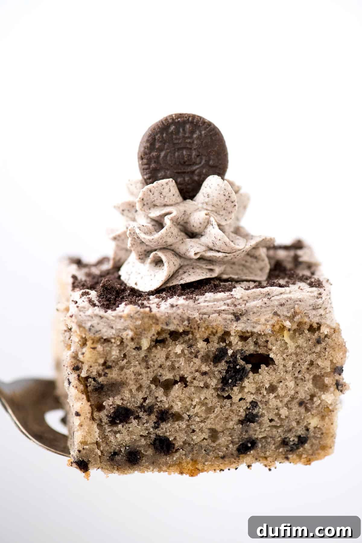 Slice of Oreo cake with Oreo frosting on metal spatula