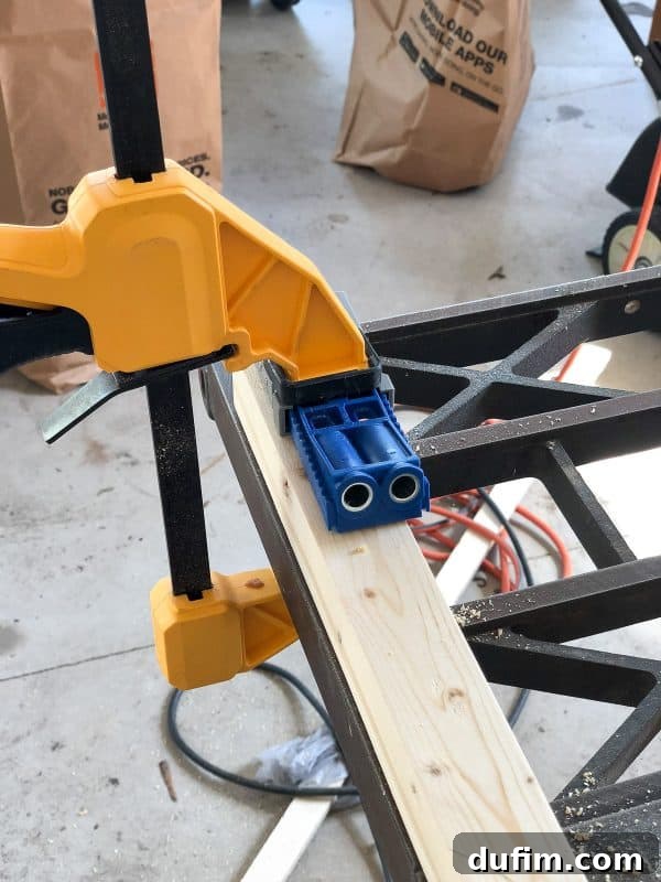 Using a Kreg Jig to drill pocket holes in a piece of wood for the console table