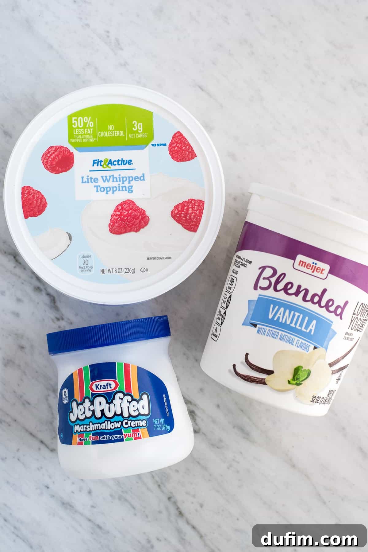 Just 3 ingredients: marshmallow fluff, vanilla yogurt, and cool whip for the easiest fruit dip ever! Three essential ingredients for the marshmallow fruit dip: a tub of vanilla yogurt, a container of marshmallow fluff, and a bowl of whipped topping, ready to be combined into a delectable dip.