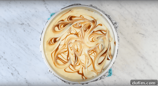 Decadent Twix Cheesecake 2 The graham cracker crust mixture pressed firmly into a springform pan, ready for pre-baking.