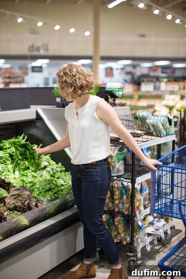 woman shopping for spinach in a grocery store, showcasing a sponsored product