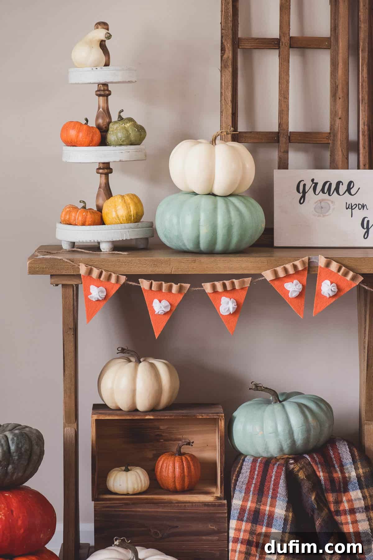 Beautifully Hung Felt Pumpkin Pie Thanksgiving Garland Finished DIY felt pumpkin pie garland hanging beautifully over a fireplace mantel, enhancing Thanksgiving home decor.