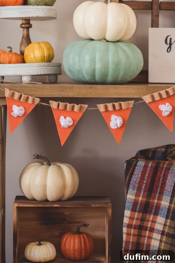 Easy Felt Pumpkin Pie Banner for Fall and Thanksgiving Decor Close-up of a DIY felt pumpkin pie garland showing individual pie slices and fluffy whipped cream details.