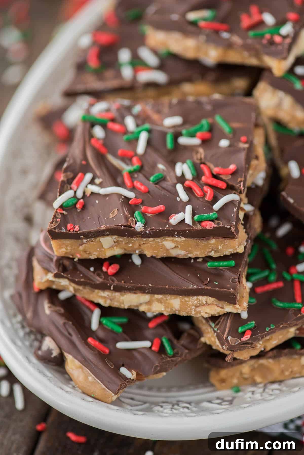 Smooth, melted chocolate spread over the warm toffee, ready for sprinkles, illustrating the perfect chocolate layer.