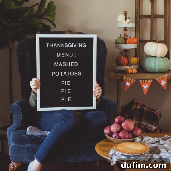 Thanksgiving menu letter board displaying traditional holiday dishes like 'Turkey, Stuffing, Mashed Potatoes, Pie' with festive decorations.