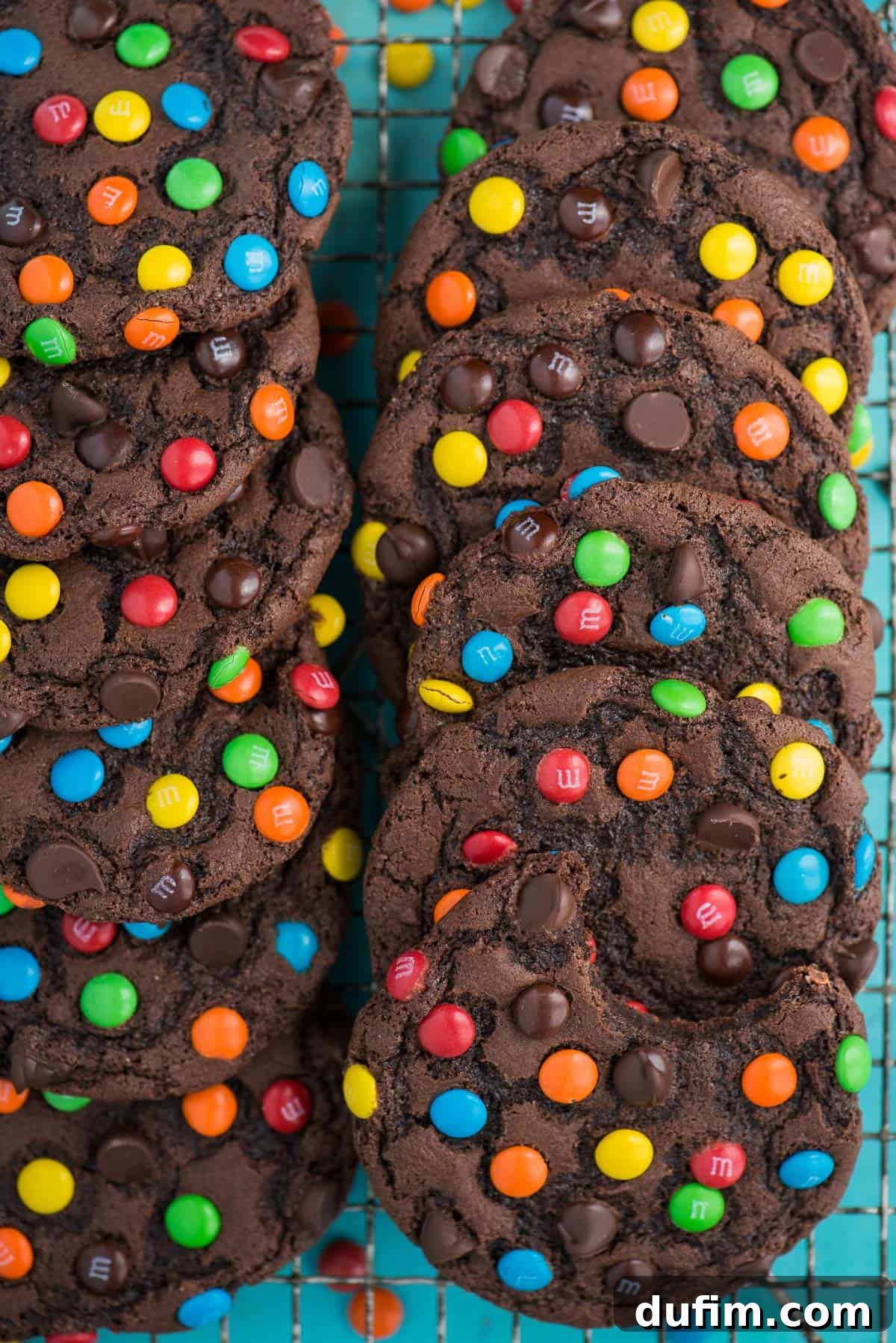 These double chocolate M&M cookies are easy to make, only 20 minutes from start to finish. Plus no chilling of the dough! These m&m cookies are chocolate-y, chewy & soft and loaded with m&m's and chocolate chips. #chocolatemmcookies #doublechocolatecookies #mmcookies double chocolate chip cookies with m&m's and chocolate chips on cooling rack