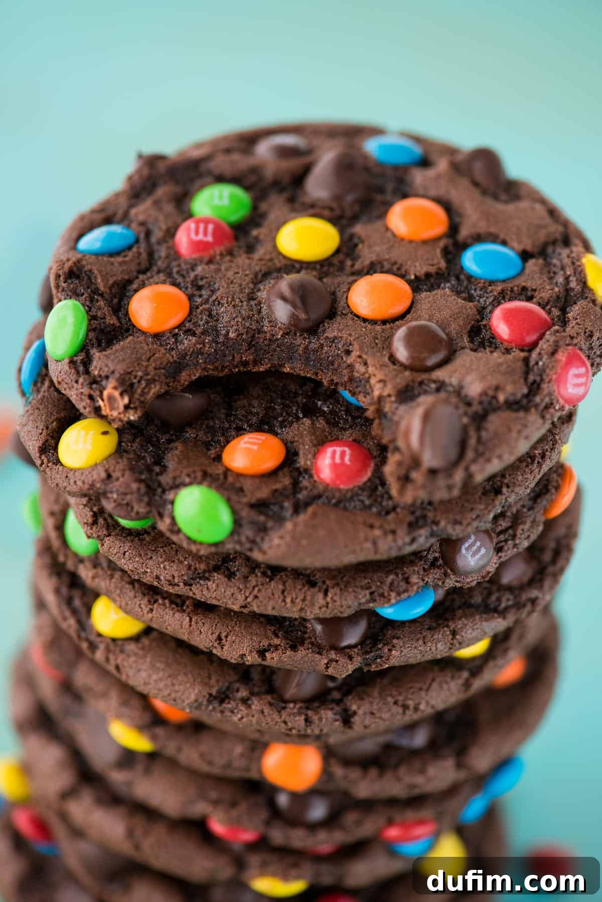 These double chocolate chip M&M cookies are easy to make, only 20 minutes from start to finish. Plus no chilling of the dough! These m&m cookies are chocolate-y, chewy & soft and loaded with m&m's and chocolate chips. #chocolatemmcookies #doublechocolatecookies #mmcookies double chocolate chip cookies with m&m's and chocolate chips stacked in a pile