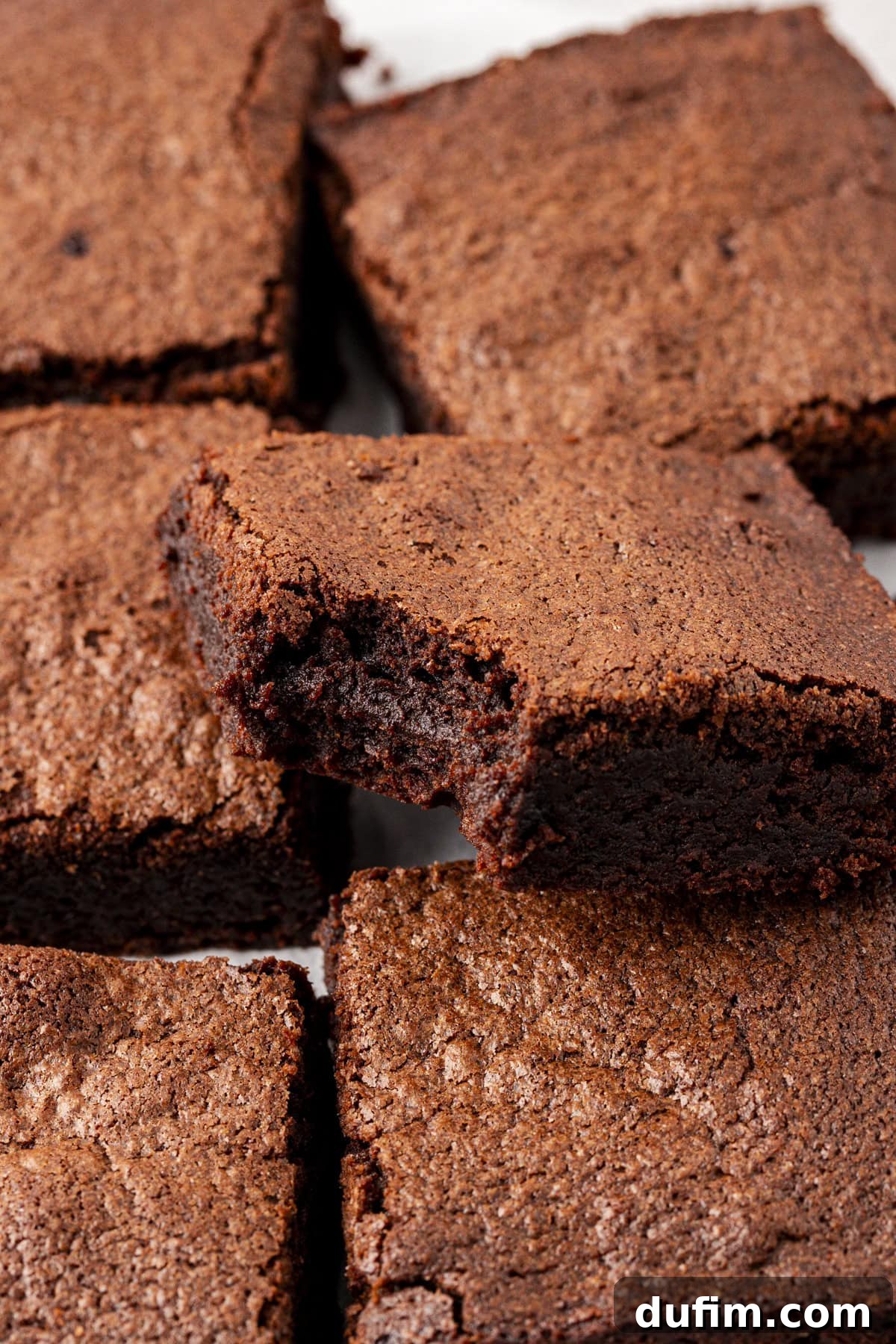Decadent Chocolate Brownies 19 A delicious homemade brownie with a bite taken out, revealing its dense, moist, and fudgy interior, showcasing the perfect texture.
