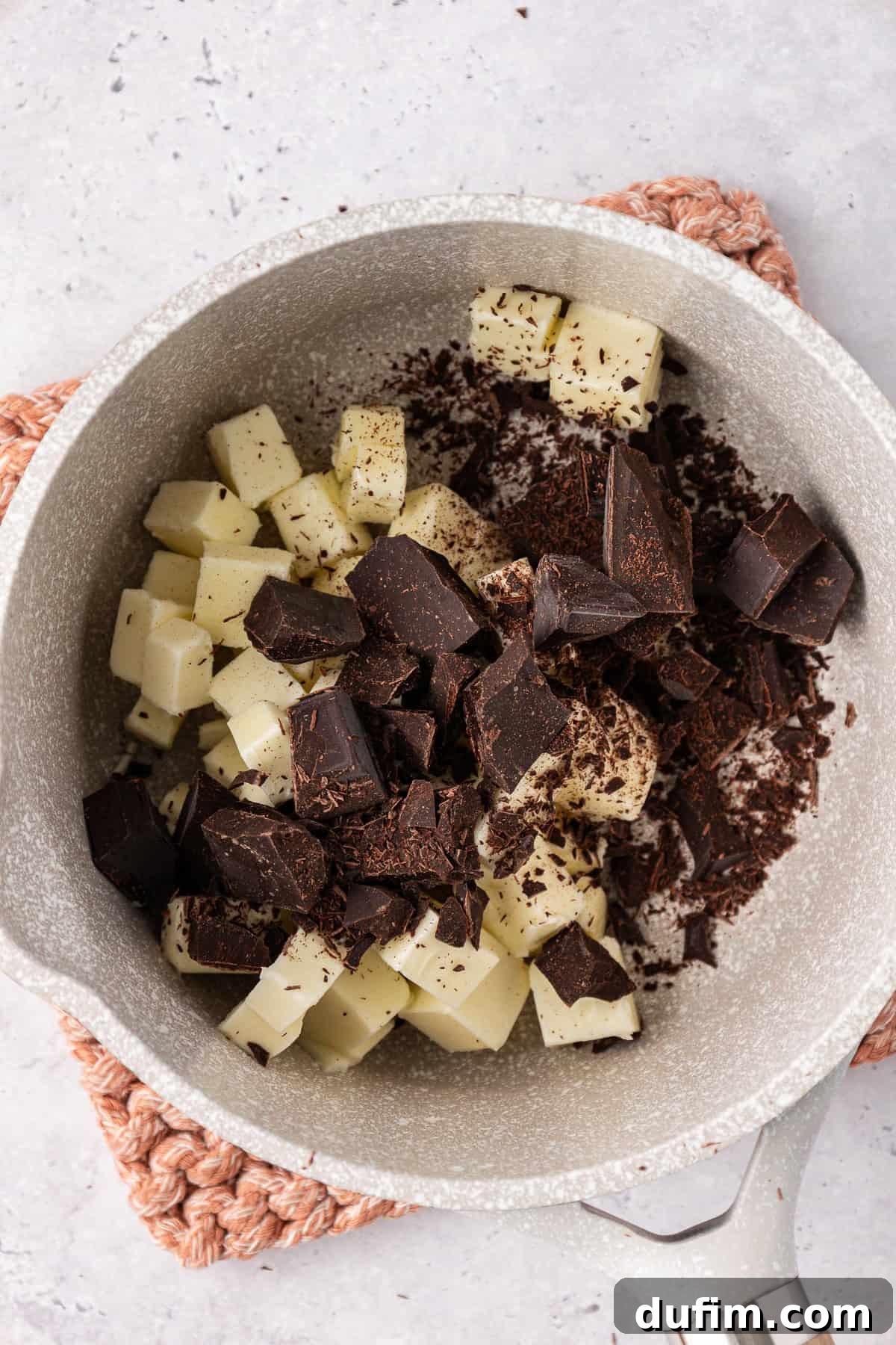 Decadent Chocolate Brownies 8 Step 3: Unsweetened chocolate and cubed butter melting slowly in a small saucepan over low heat, beginning to form a glossy mixture.