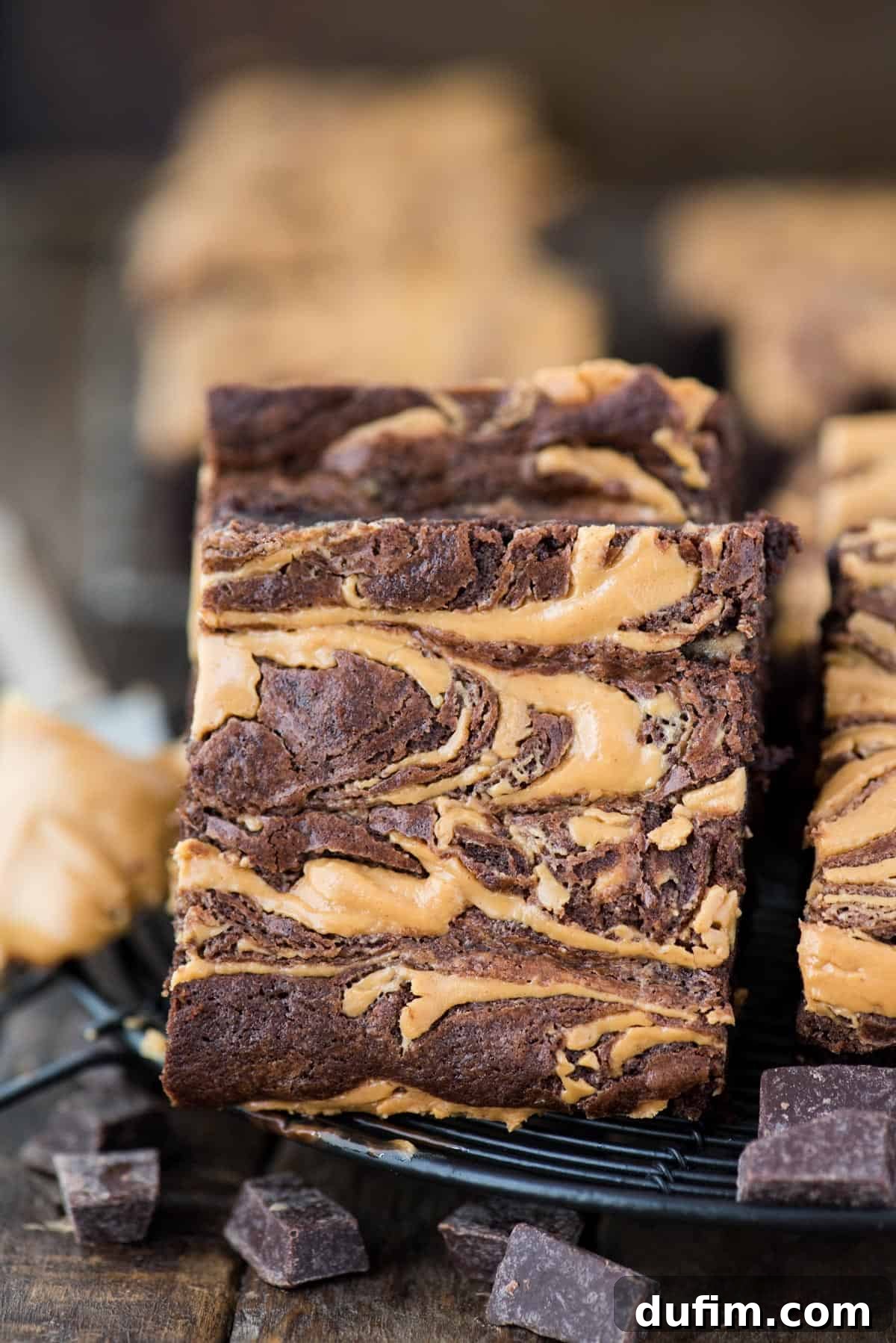peanut butter swirl brownie slice on black wire trivet with chocolate chucks