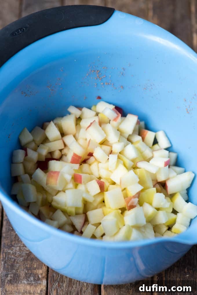 Effortless Apple Spice Coffee Cake 4 Freshly diced apples, ready to be incorporated into the apple coffee cake batter, showcasing their crisp texture and vibrant color.