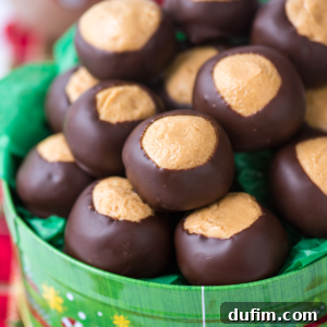 A green bowl is filled with chocolate-dipped peanut butter balls, known as buckeyes, each displaying a round shape and exposed peanut butter centers.