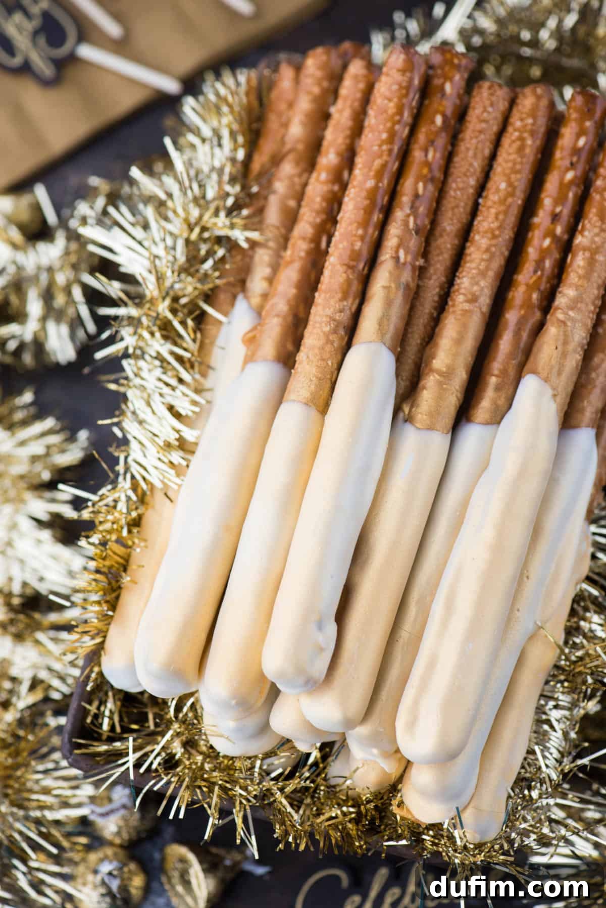 Golden New Year's Eve pretzel rods, beautifully dipped in rich caramel and smooth white chocolate, glistening with edible gold paint. Perfect festive treats for holiday parties.