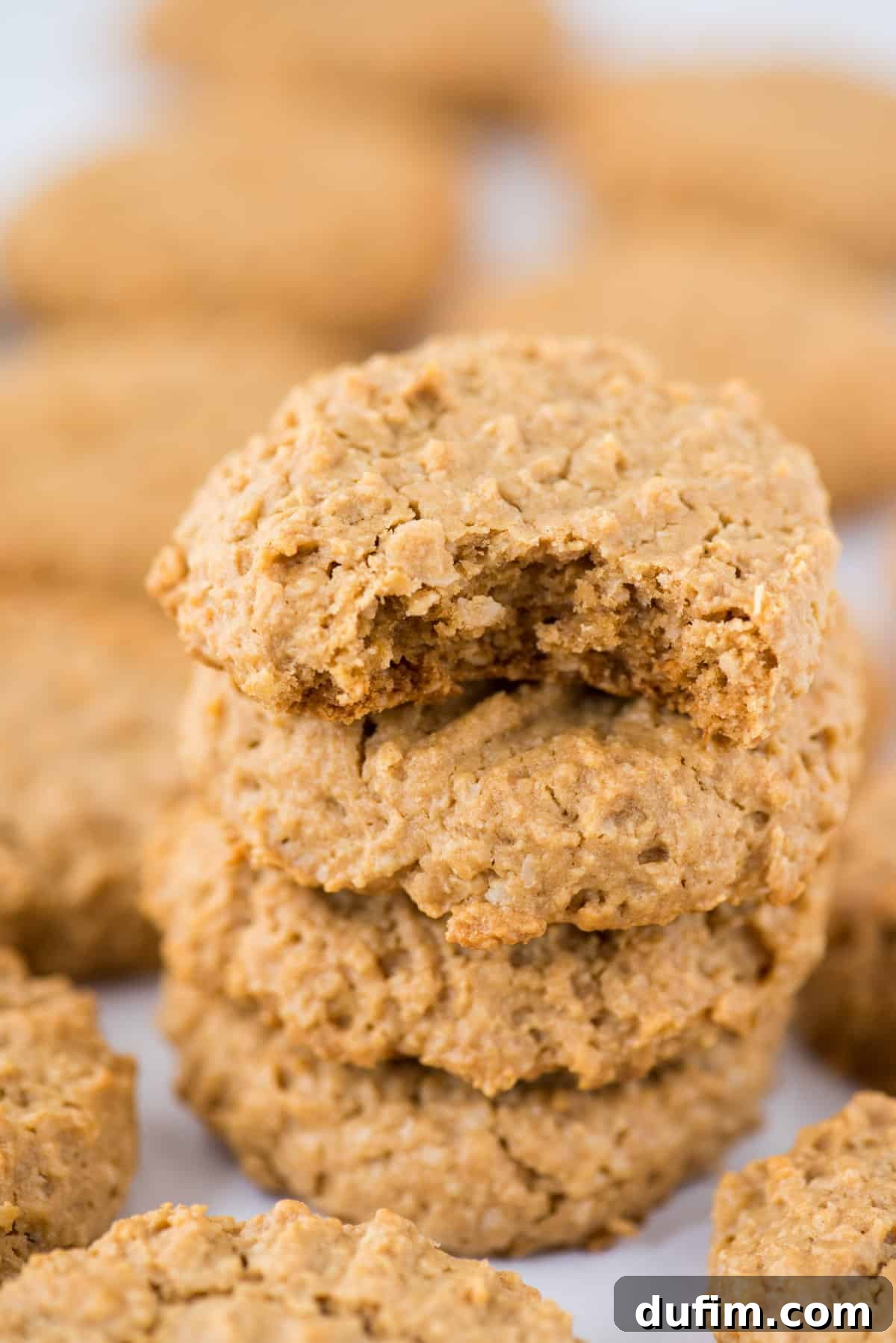 Guilt-Free Peanut Butter Oatmeal Treats 4 A close-up shot of a stack of healthy peanut butter cookies on a clean white background, highlighting their golden-brown color and characteristic fork marks.