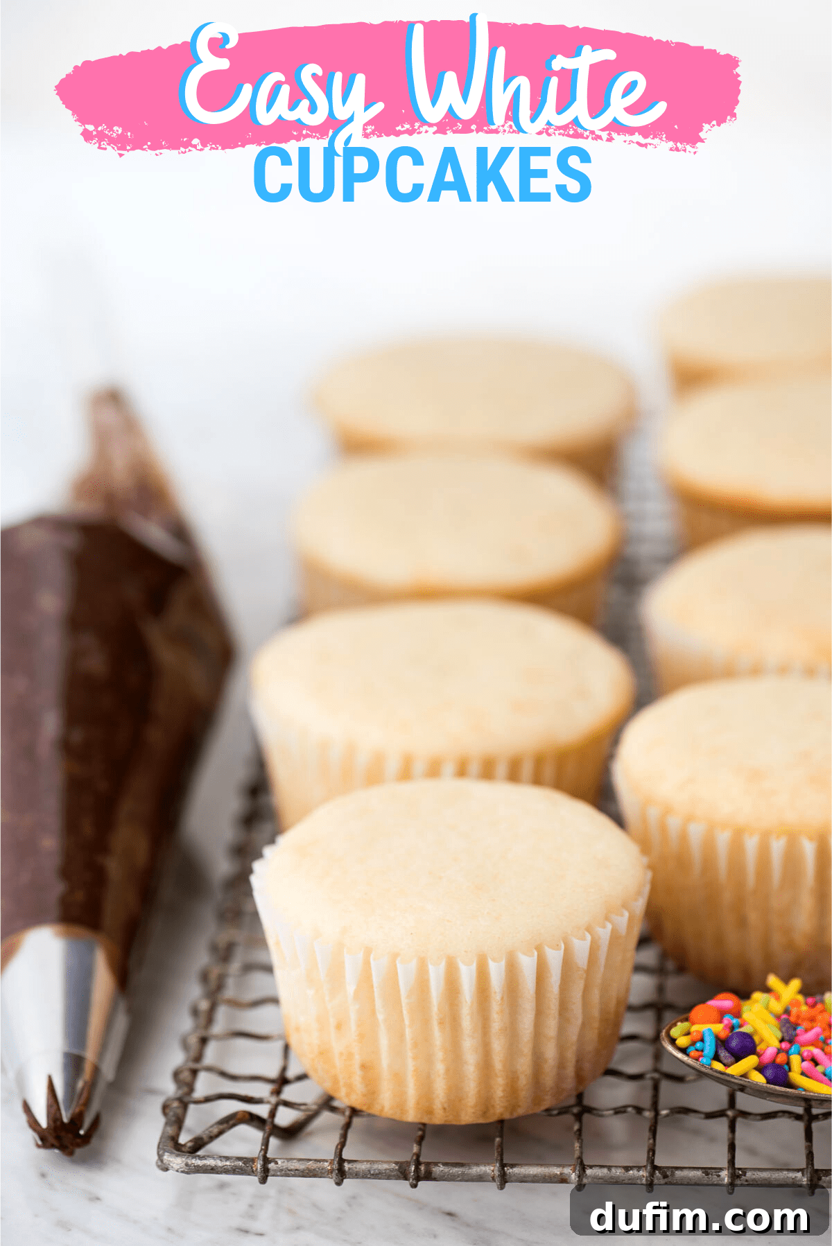 Deliciously Simple White Cupcakes 5 unfrosted white cupcakes on wire cooling rack