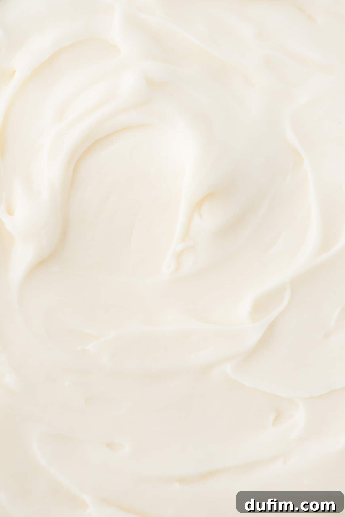 Homemade Cream Cheese Frosting Perfection 6 Close-up of fluffy and smooth cream cheese frosting, perfect for any dessert.