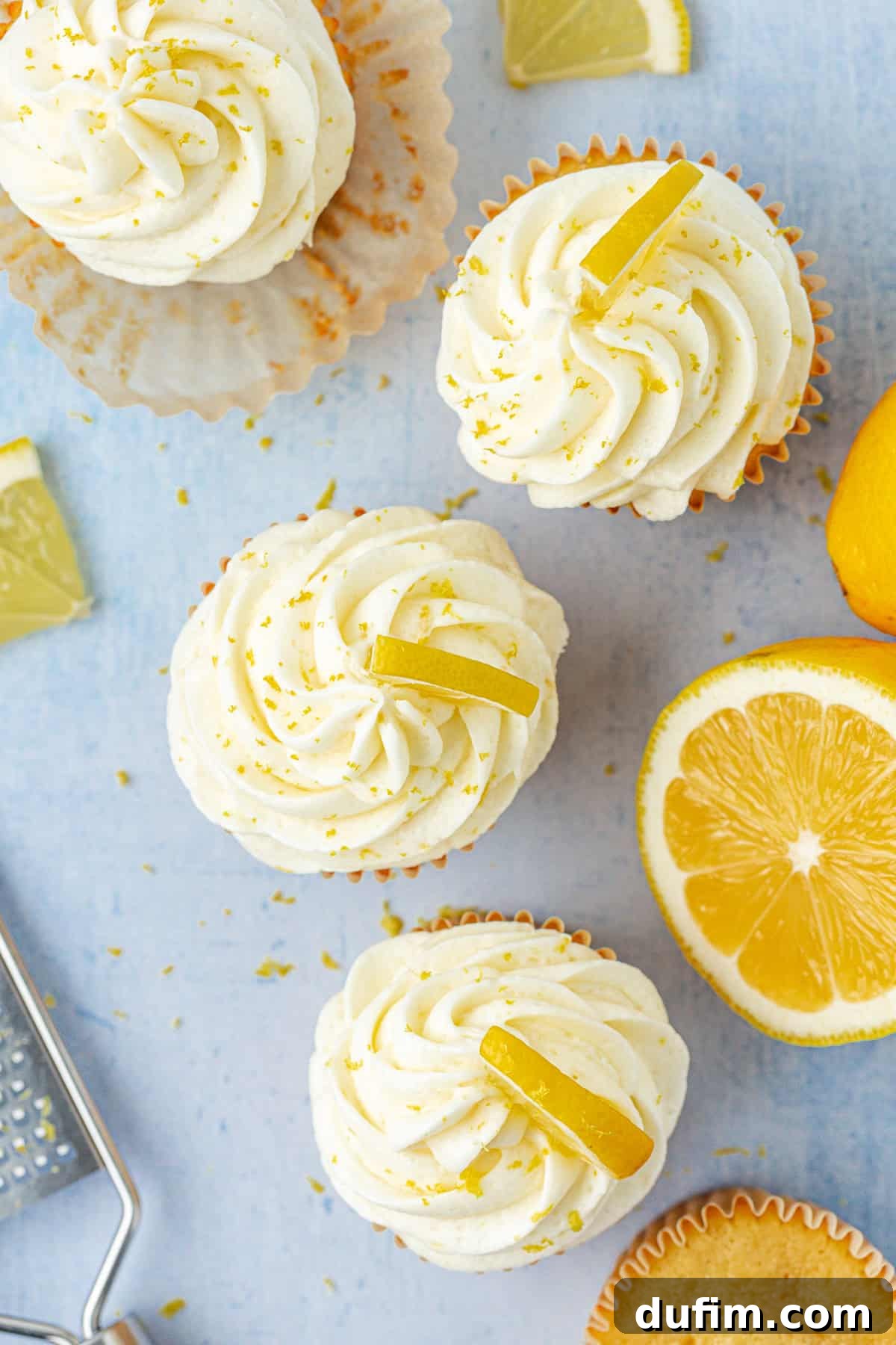 A beautifully frosted cake or cupcake with lemon buttercream, garnished with fresh lemon zest, showcasing its delightful appeal.