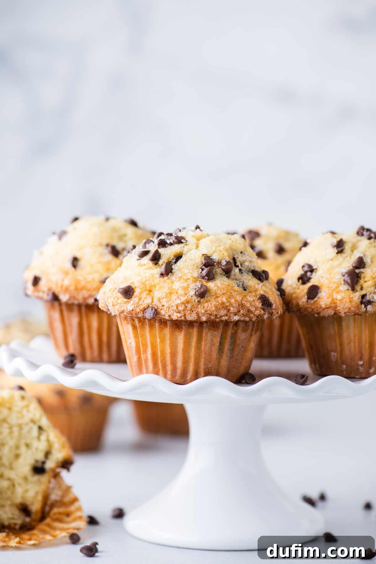 chocolate chip muffins displayed on white cake stand