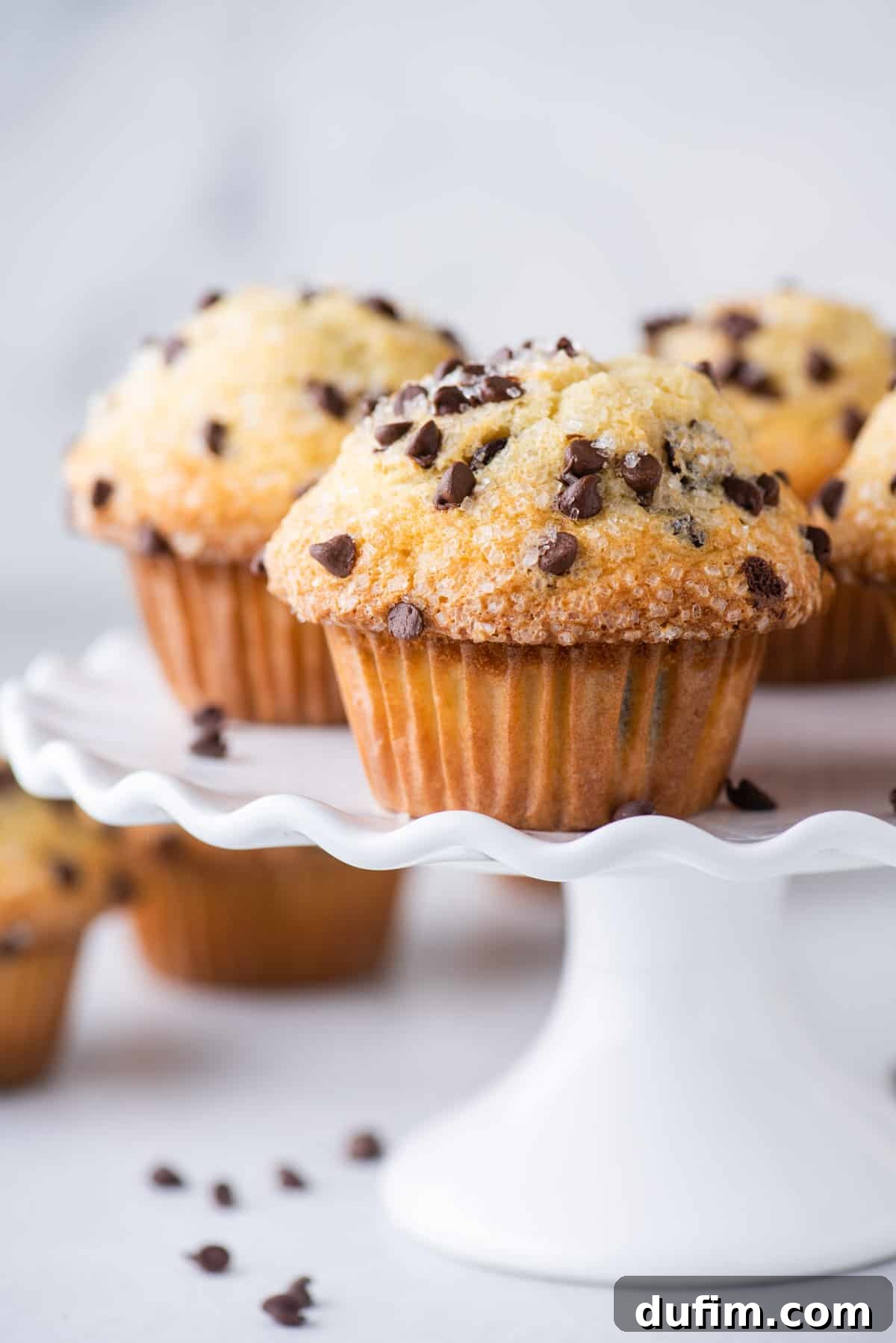 chocolate chip muffins on white cake stand