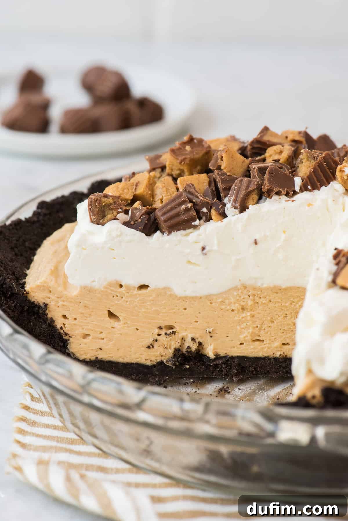 peanut butter pie with slice removed on white background