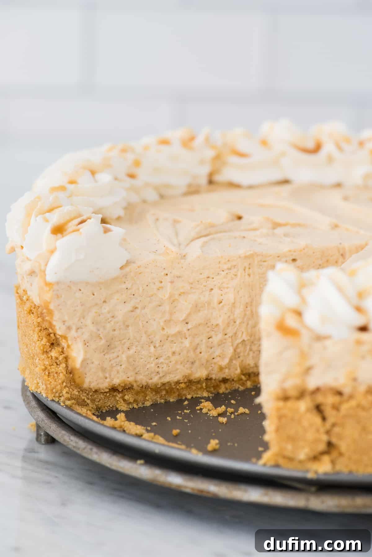 Effortless Spiced Pumpkin Cheesecake 6 inside view of pumpkin cheesecake with slice removed